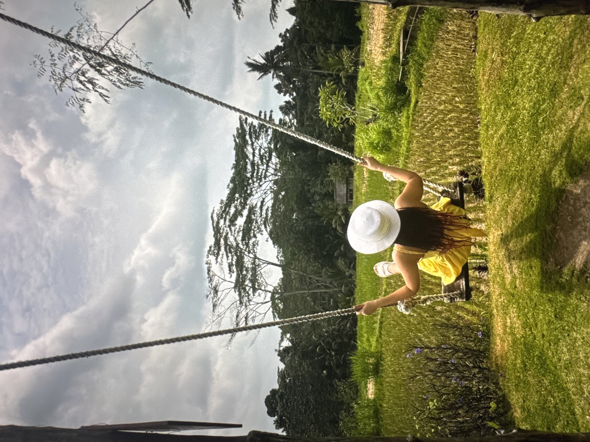 Couple enjoys outdoor recreation, woman swings while man photographs