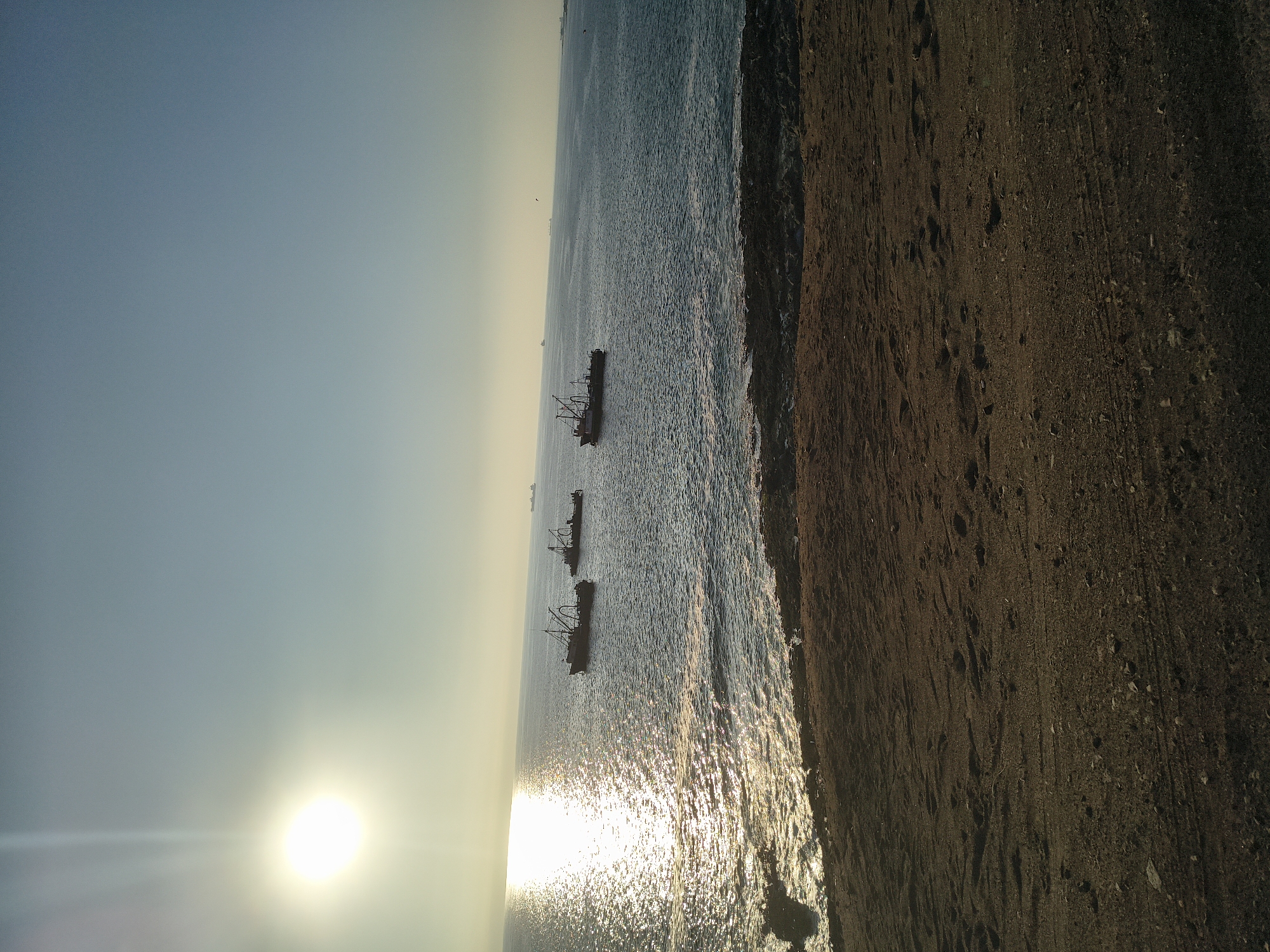 Fishing boats anchor off Arica coast during sunset