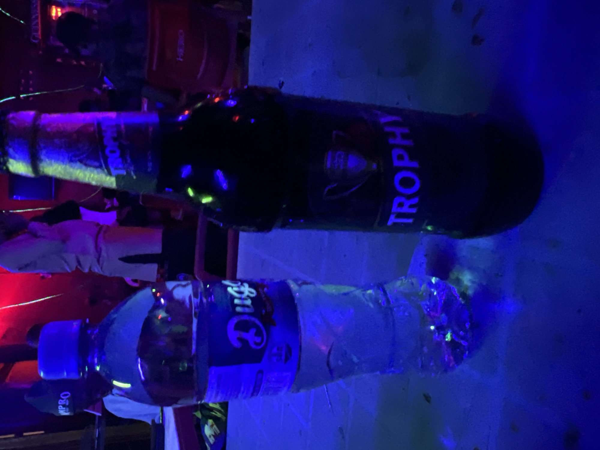 Beer and water bottles photographed under blue light in Nigeria