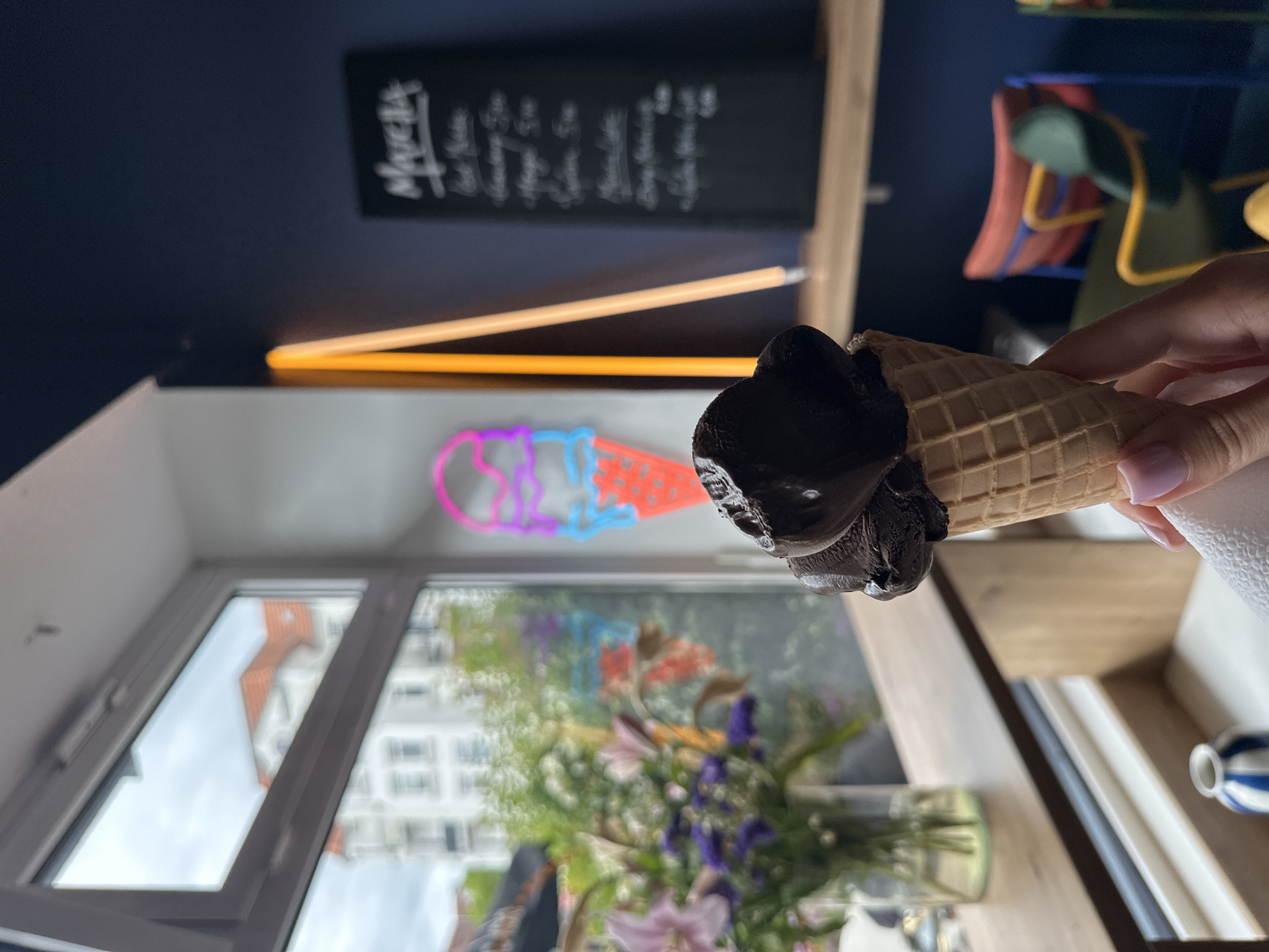 Customer enjoys chocolate ice cream at Kiel parlor