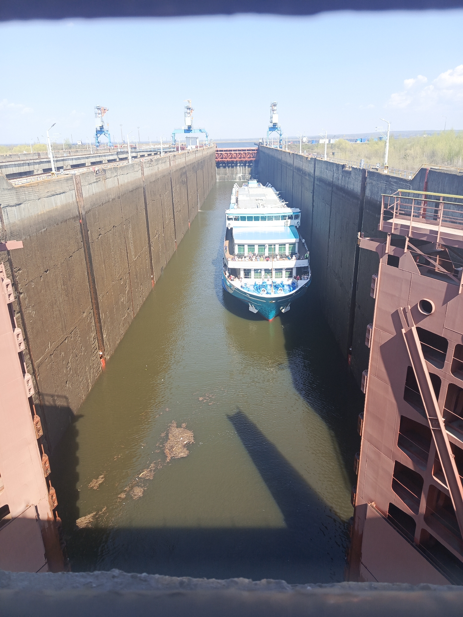 Cruise ship transits canal lock with passengers aboard