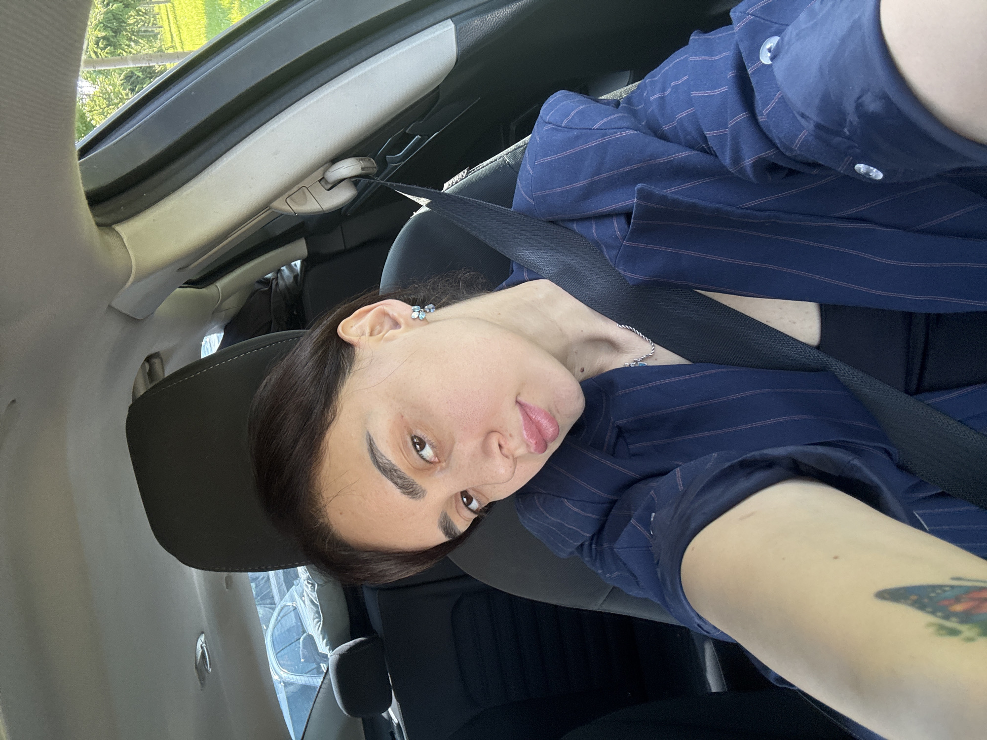 Woman takes morning selfies in car in Tbilisi