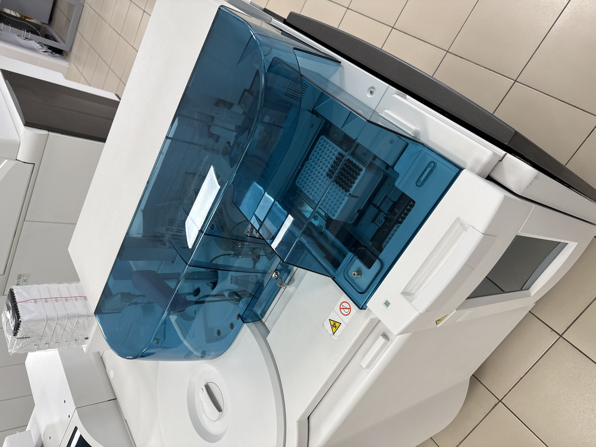 Medical analyzer with biohazard symbol observed on laboratory floor