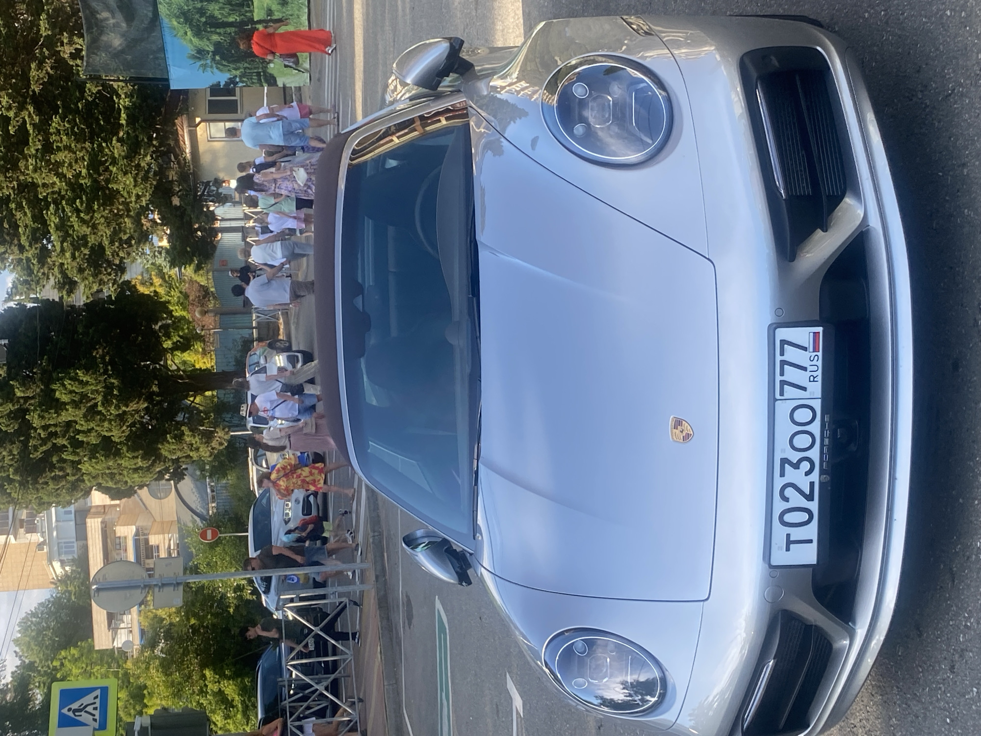 Toy vehicle rides and a parked Porsche in Sochi