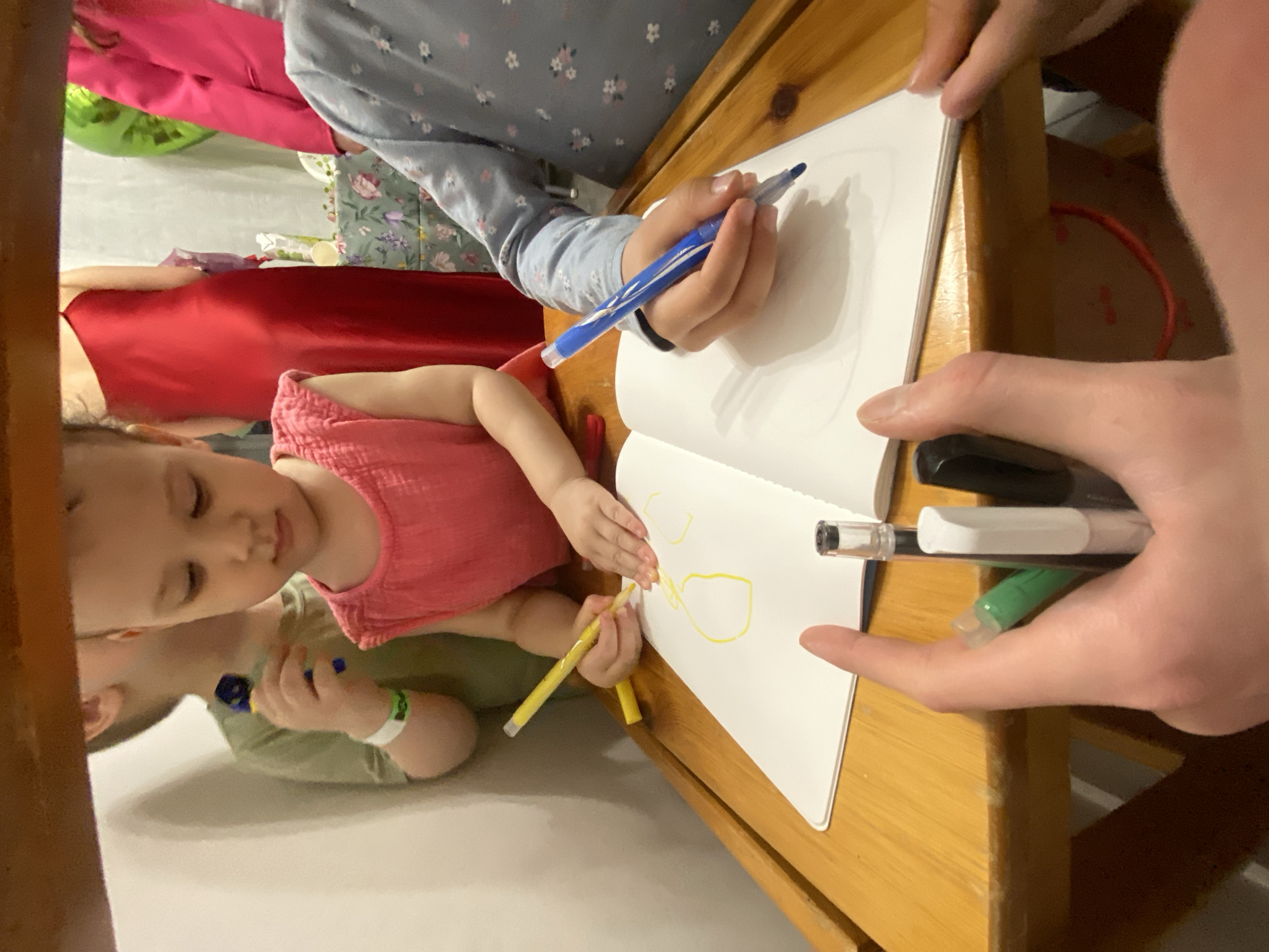Children share drawing time at Moscow table