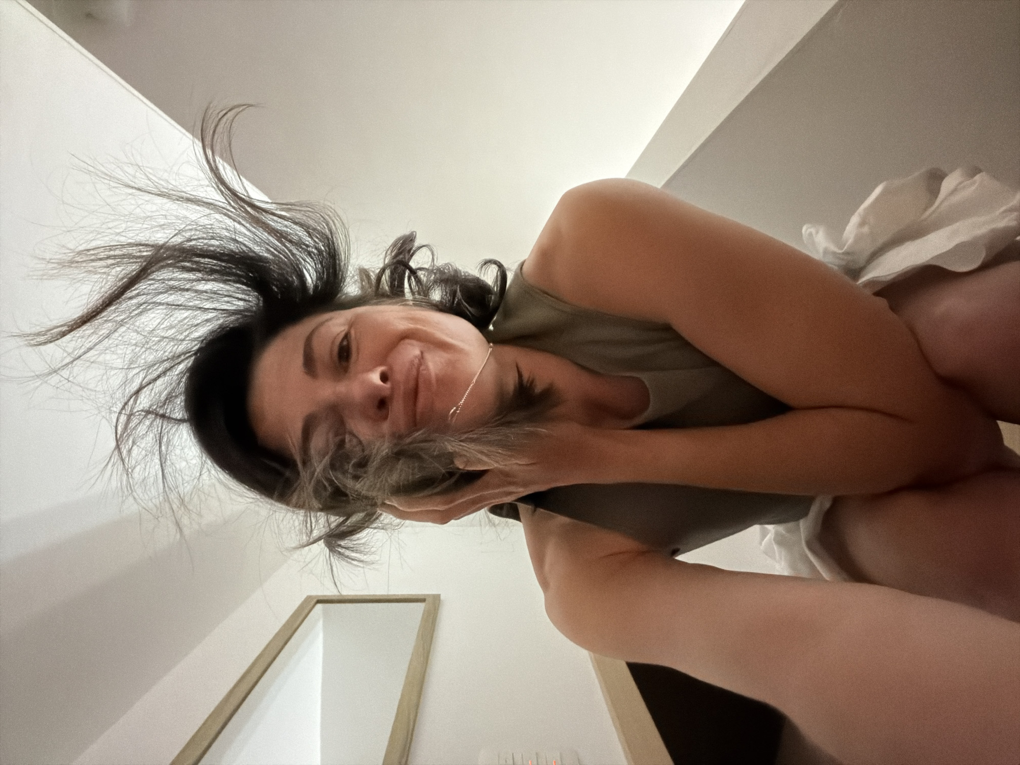 Woman photographs herself in bedroom in Budva, Montenegro