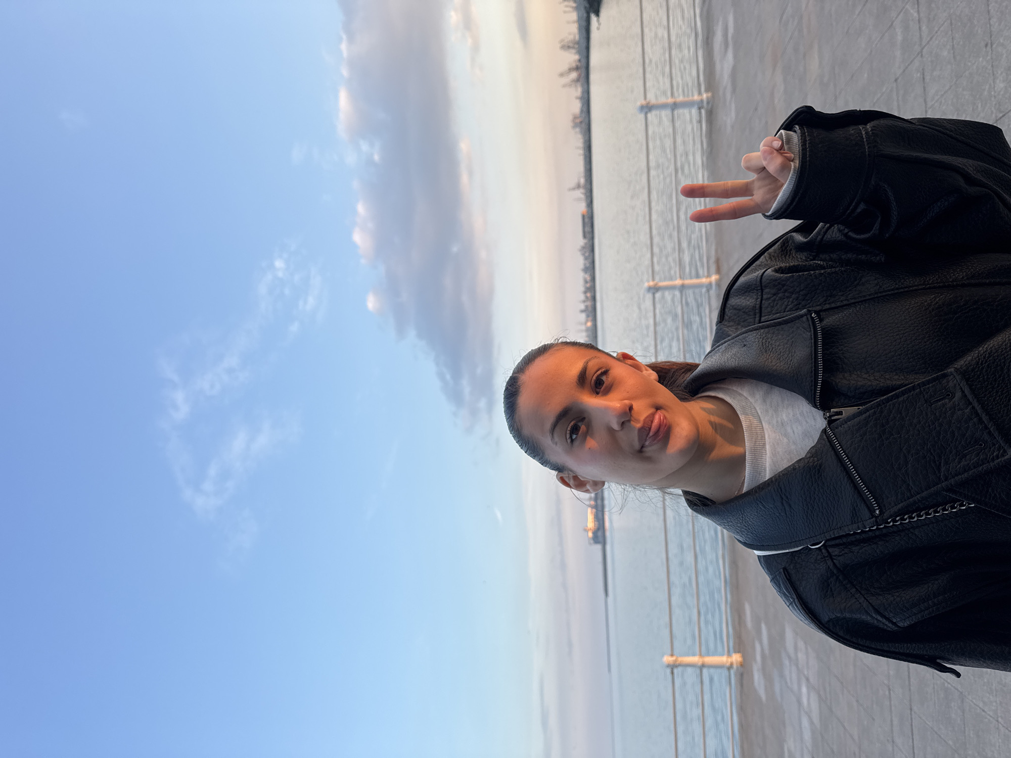 Woman takes selfie at waterfront location