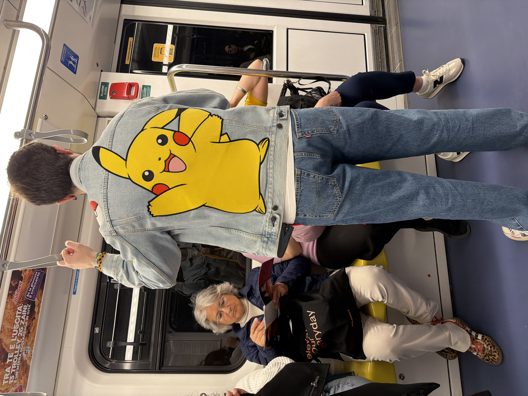 Crowded metro car observed during midday transit in Milan