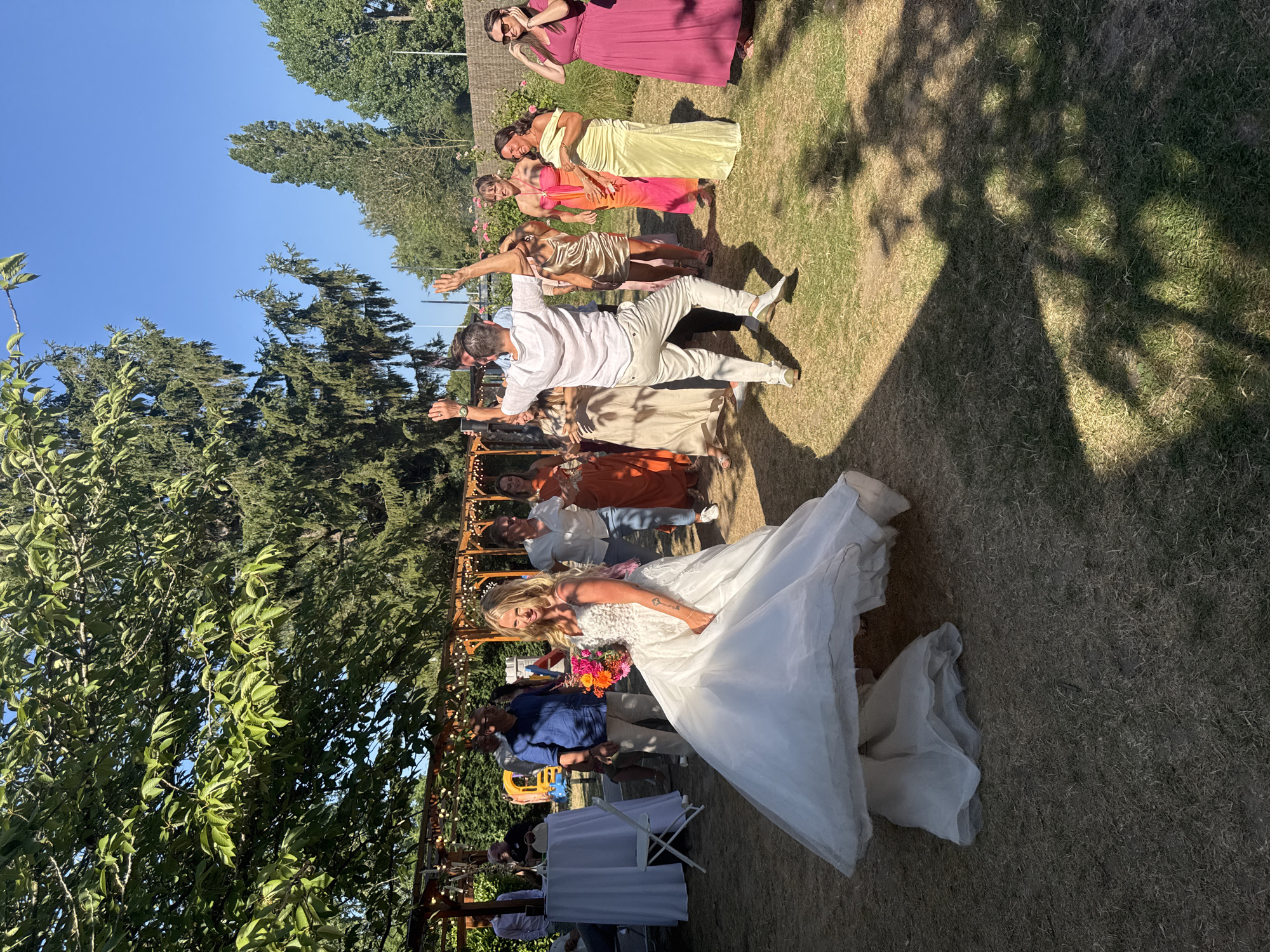 Sunny outdoor wedding reception in Hem, bouquet toss and all