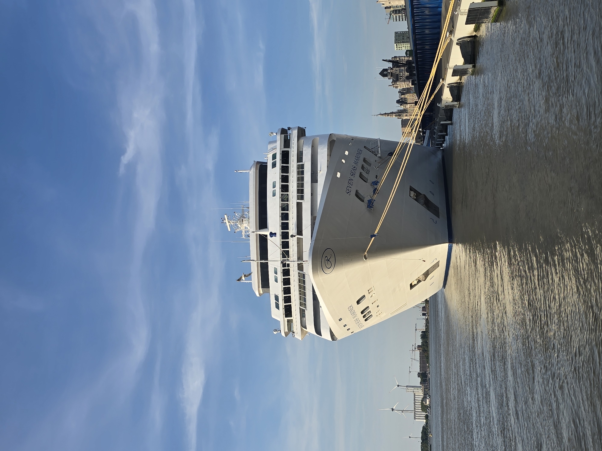 Antwerp waterfront at golden hour, cruise ship in port