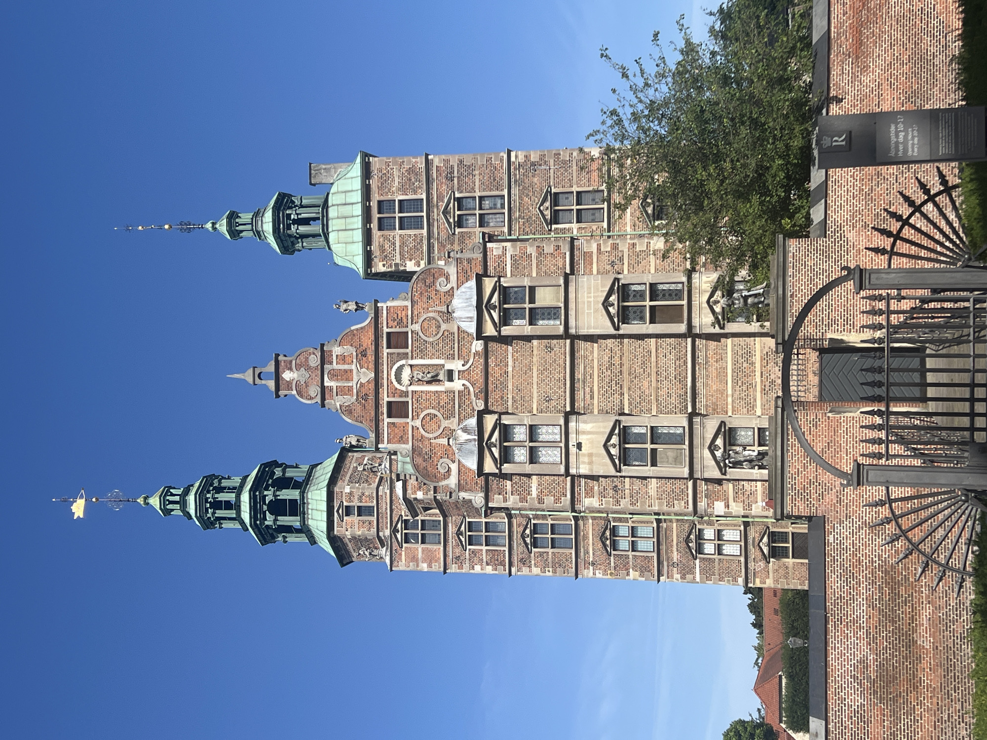 Geese roam the grounds of Rosenborg Castle on a summer morning