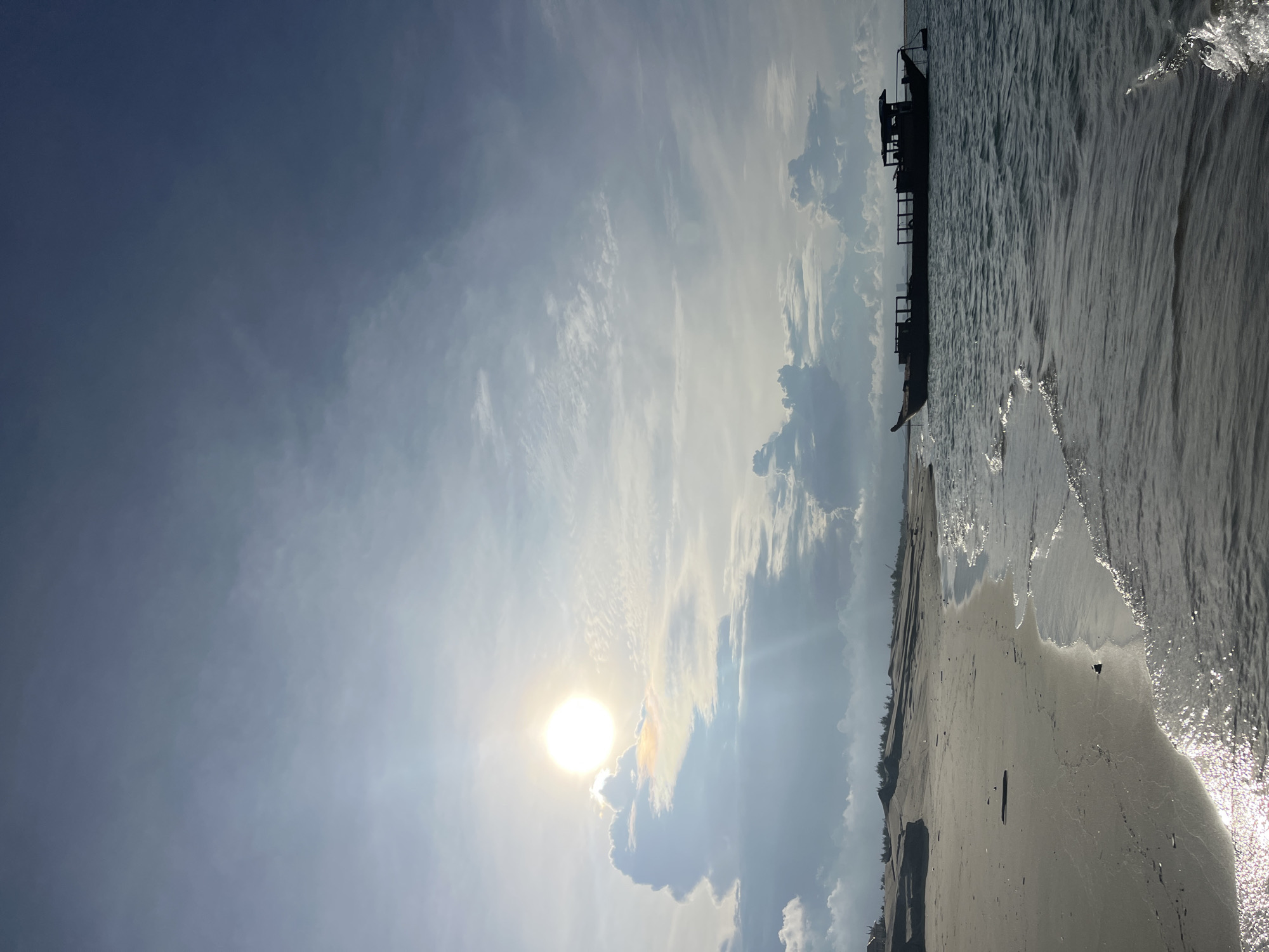 Hoi An coastline: boats, dunes, and offshore dredging on a cloudy morning