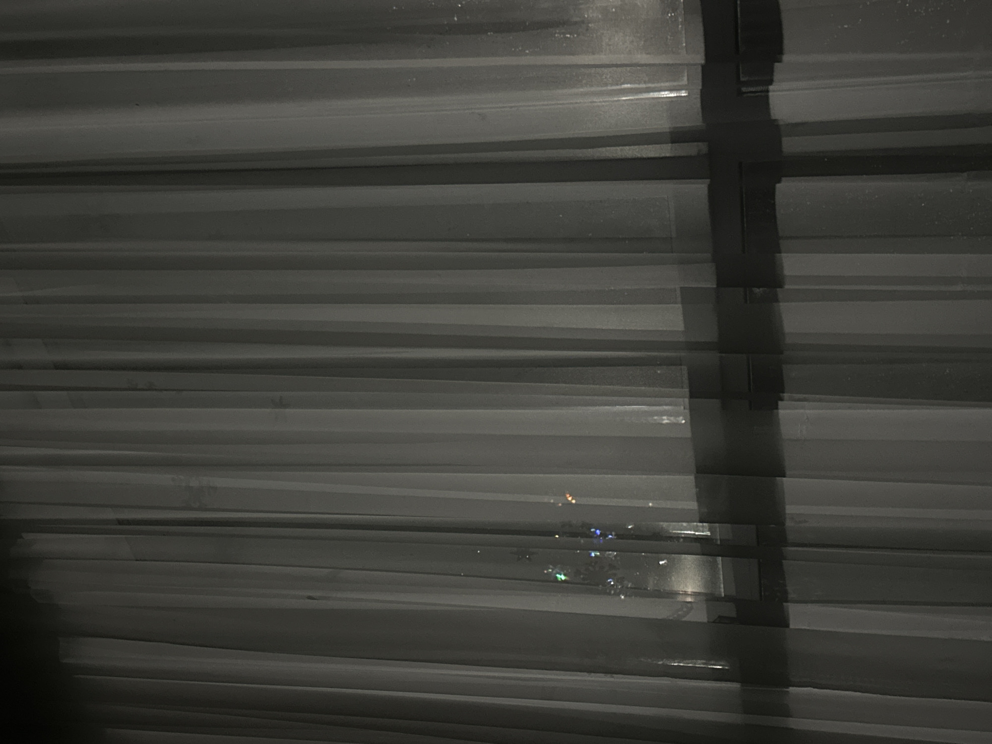 Indoor evening scene captured through venetian blinds over 21 minutes