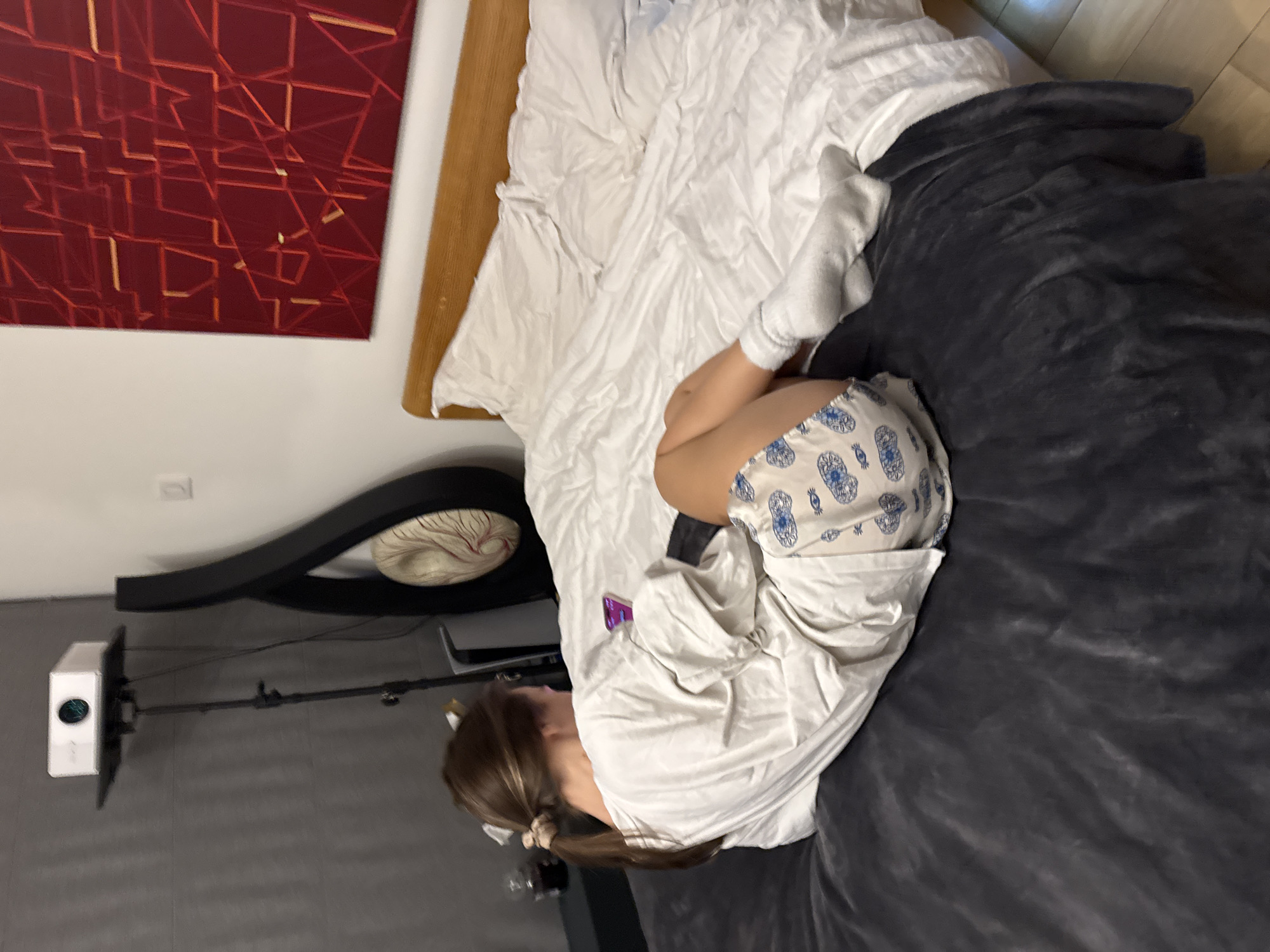 Young woman spends evening on phone in bedroom