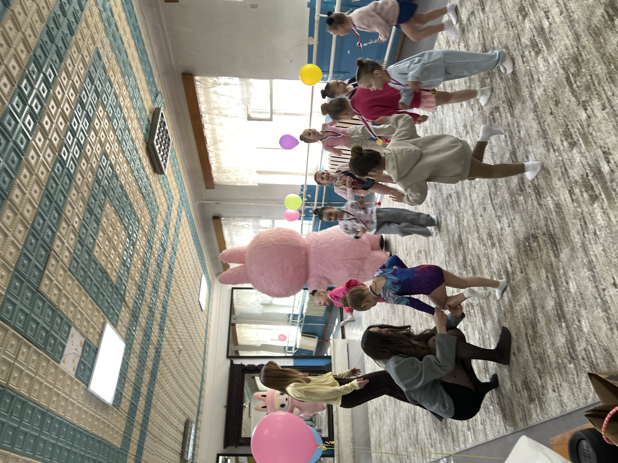 Children's medal ceremony and dance party with pink bunny mascot