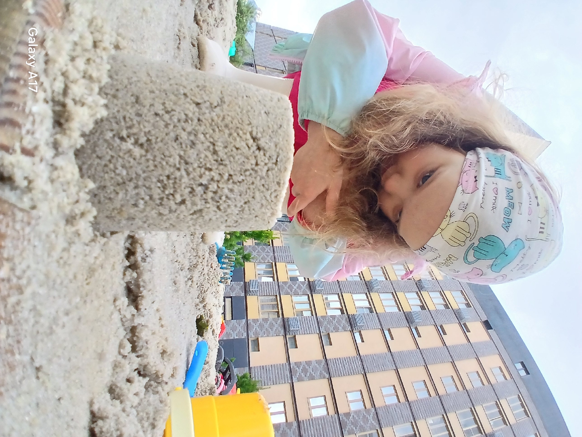 Child plays in sandbox and puddles in Yekaterinburg residential complex