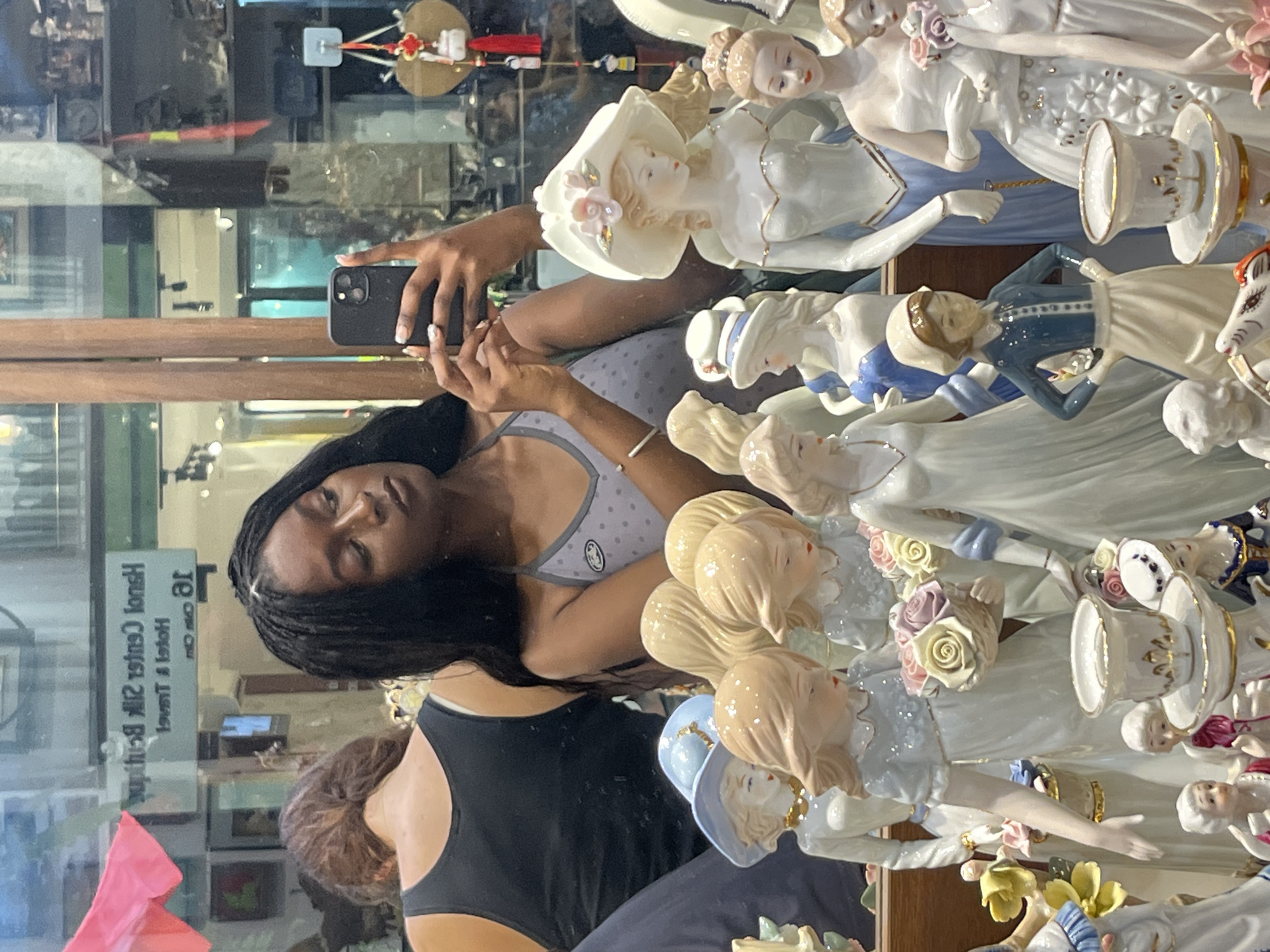 Woman takes selfie in Hanoi antique shop display