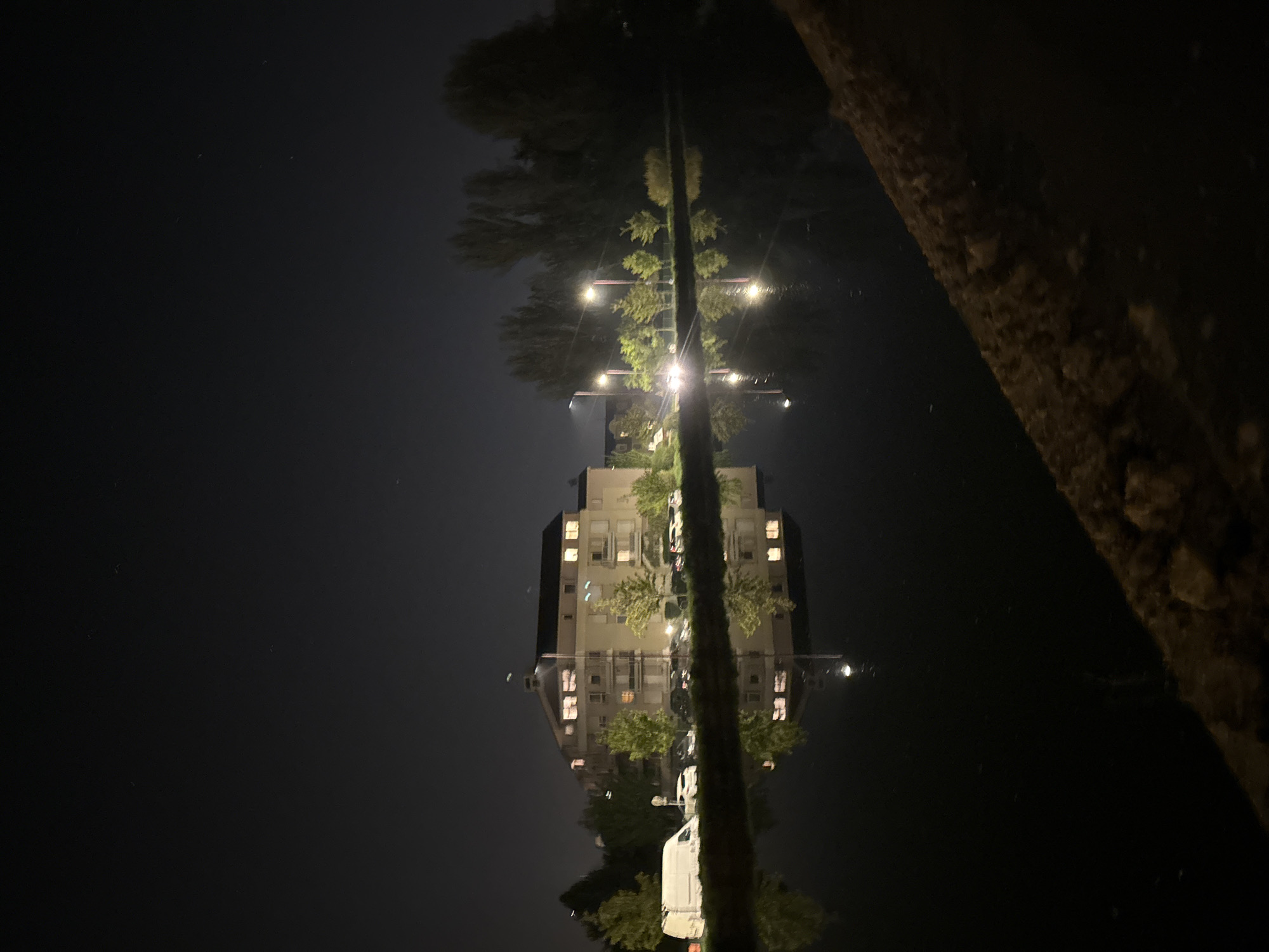 Illuminated building reflected in water at night in Bischheim