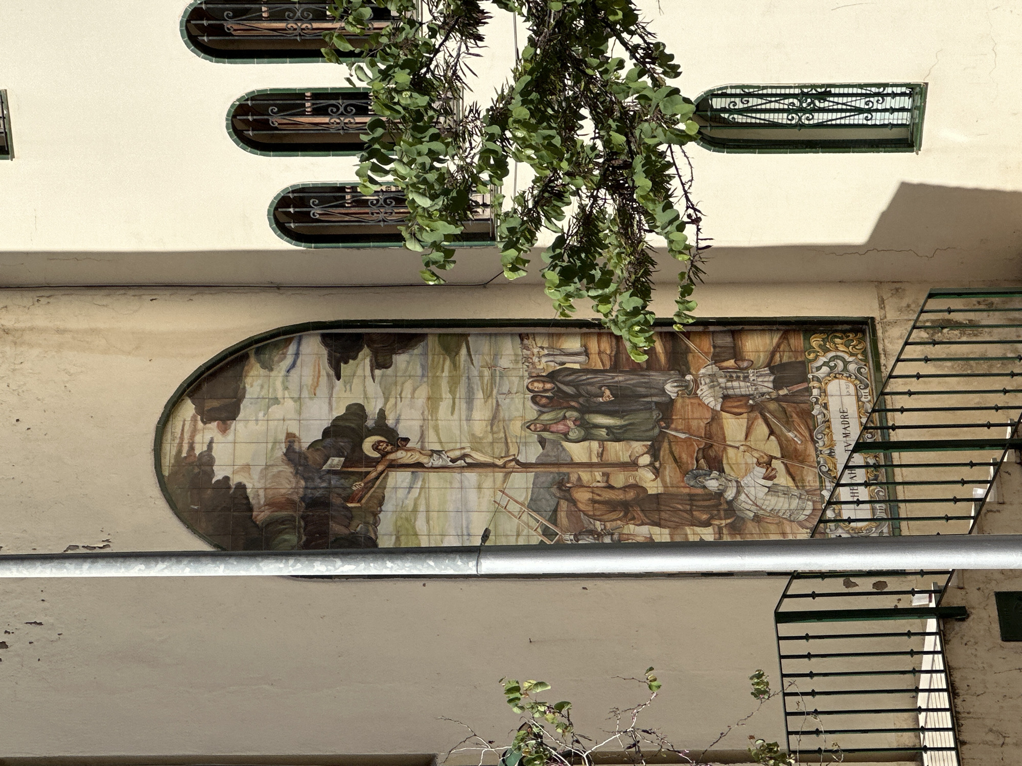 Religious crucifixion mural observed on Málaga building facade