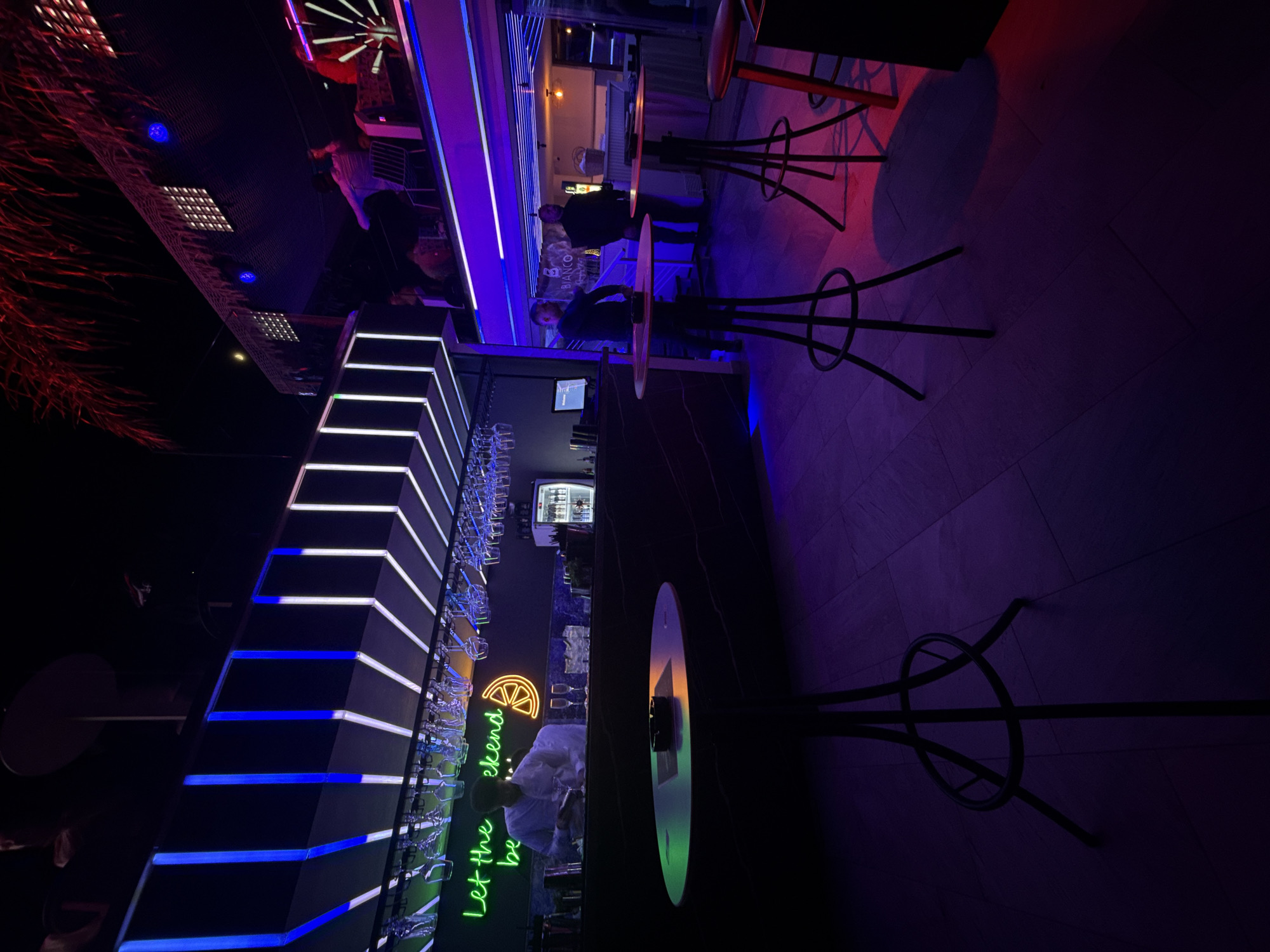 Luxury car spotted outside bustling Ksamil bar during evening hours