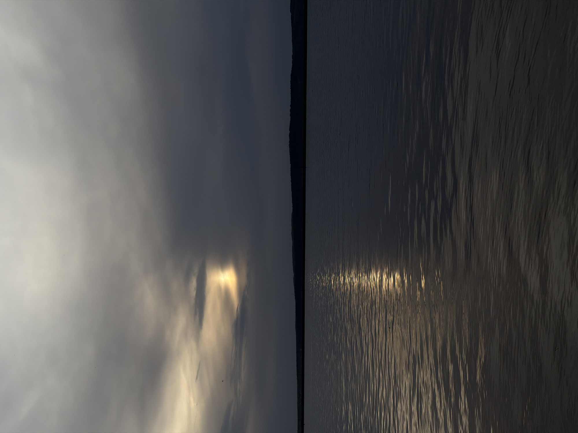 Sunlight breaks through clouds over Kama River near Chaikovsky