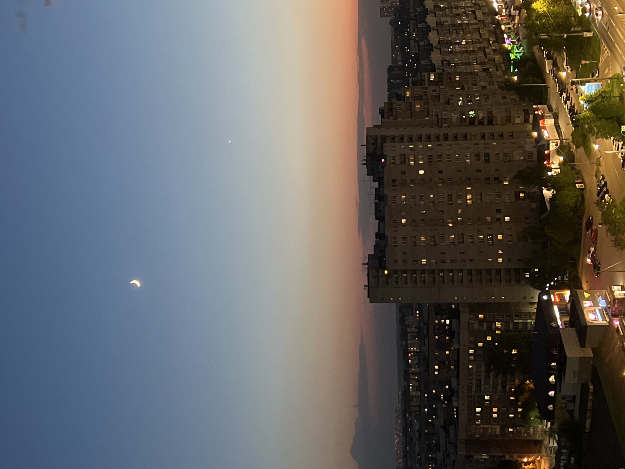 Dusk cityscape with crescent moon observed in Saint Petersburg