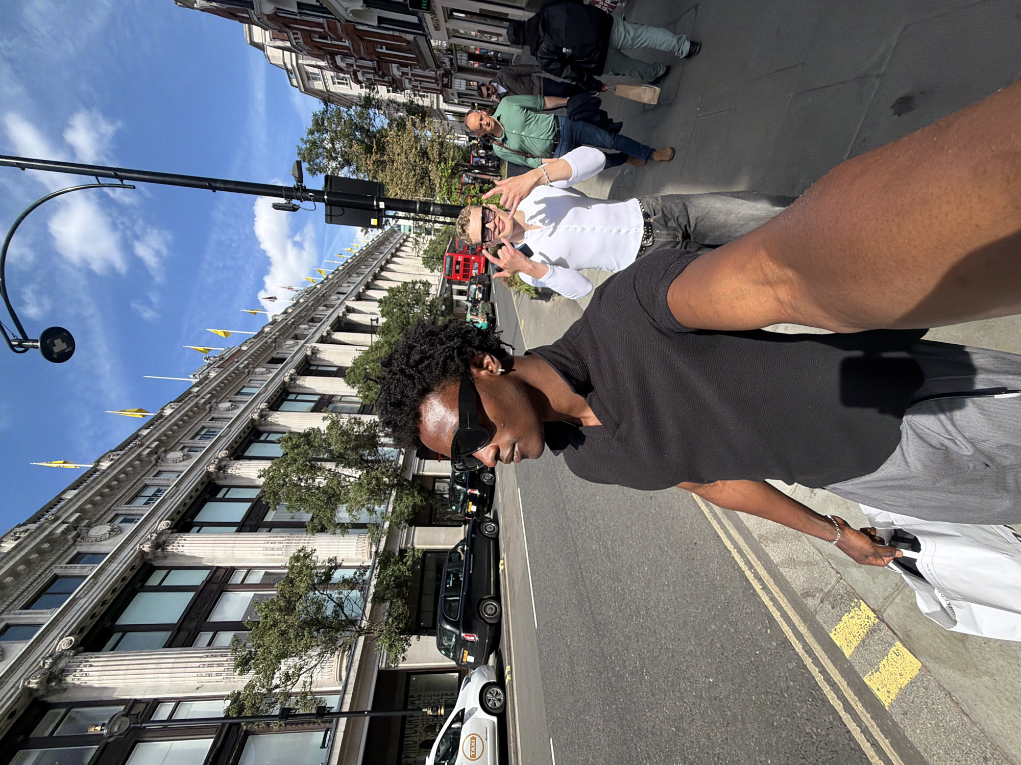 Two men take selfie on sunny London street