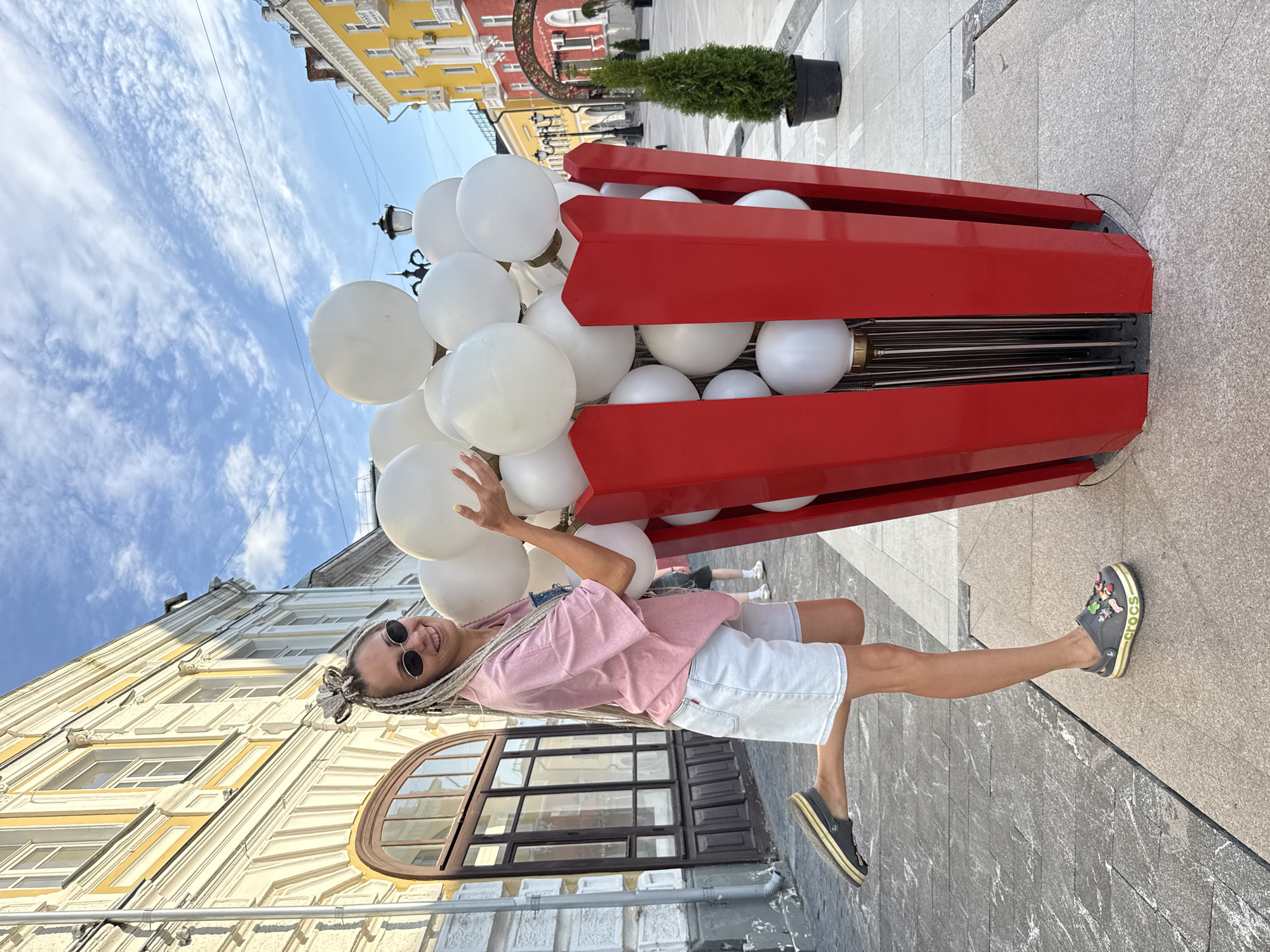 Posing with a giant red balloon-filled popcorn container in Russia