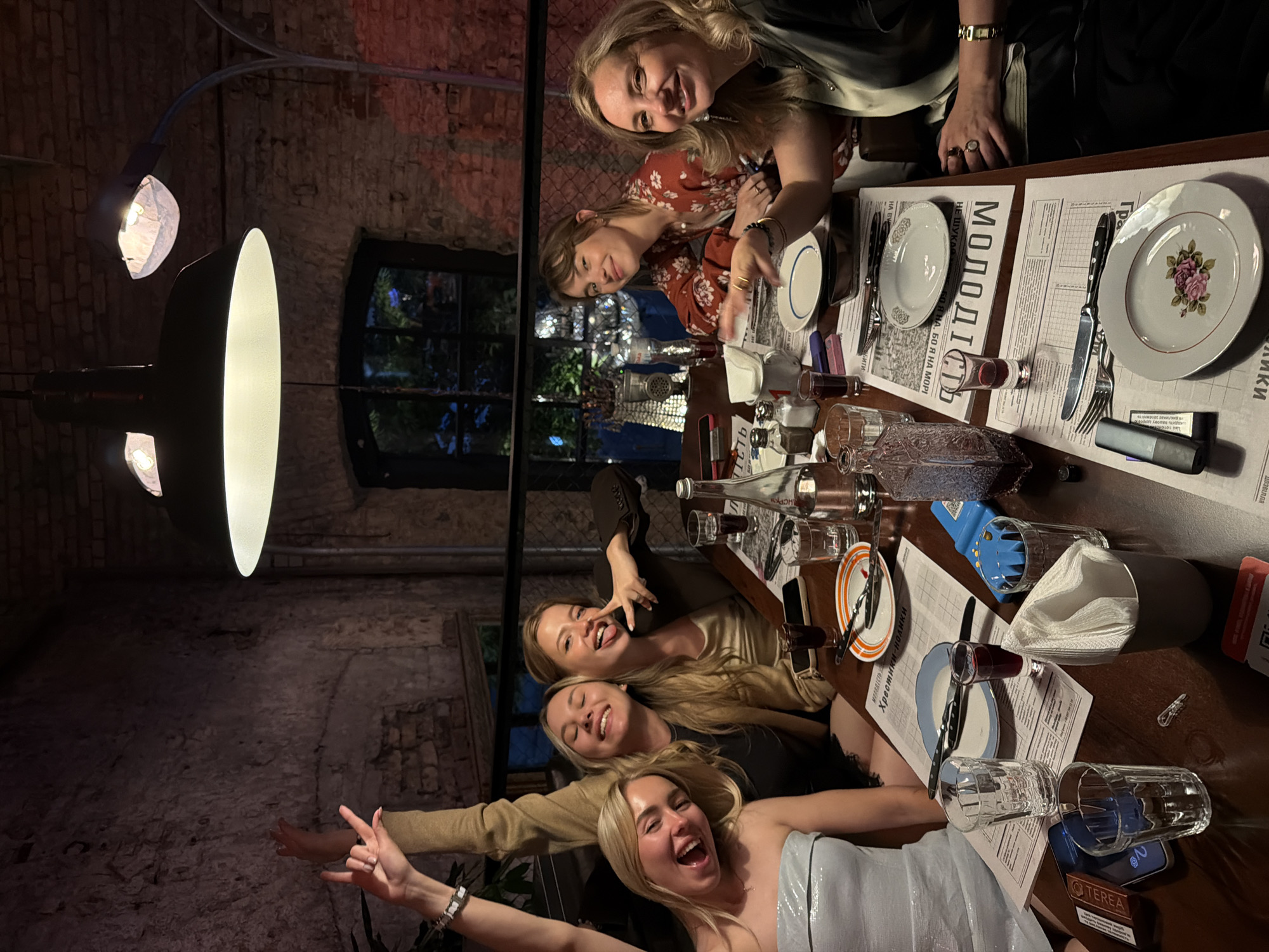 Evening dinner gathering at brick-walled restaurant in Kyiv