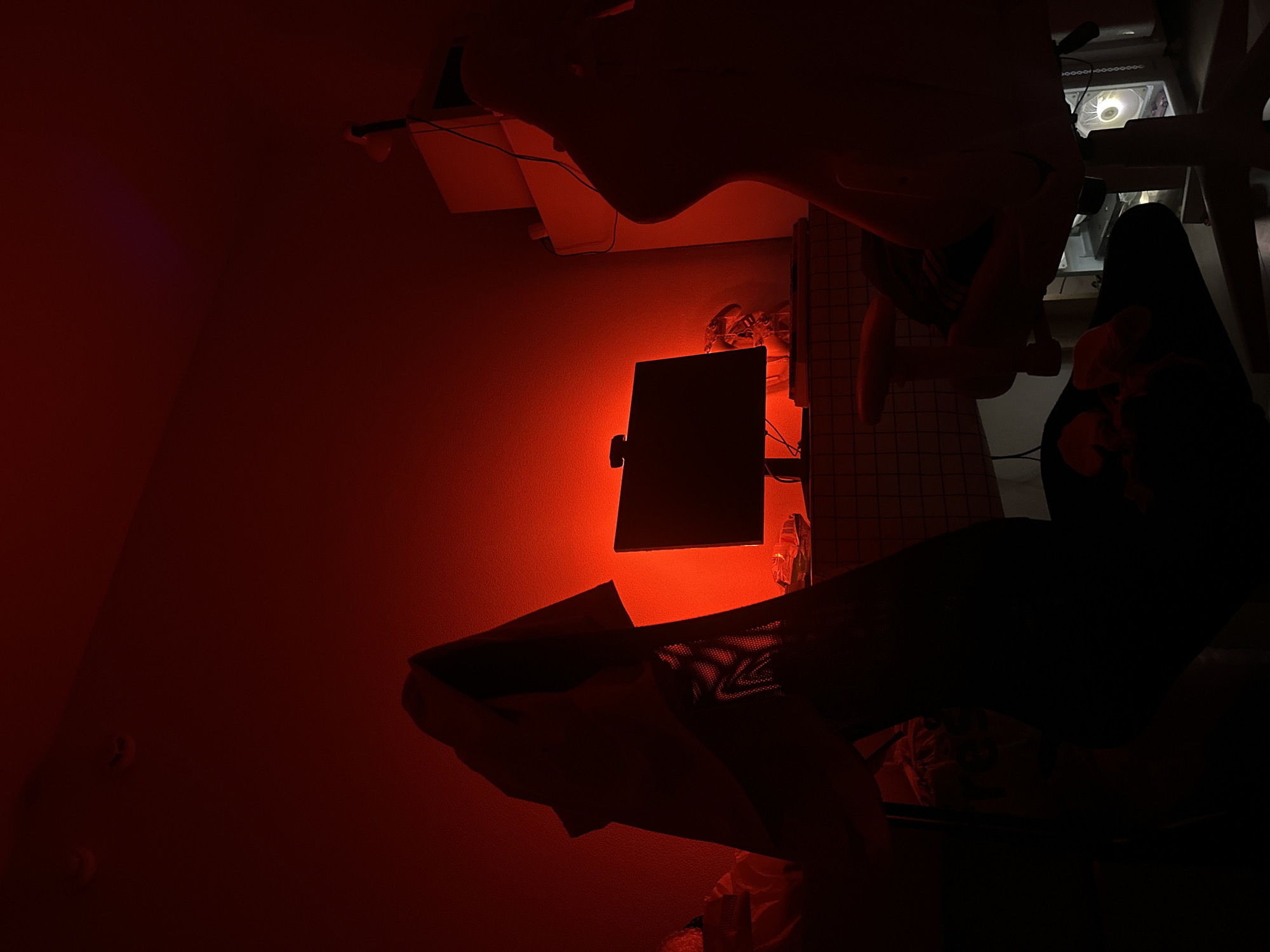 Red-lit interior with monitor and desk observed in Lyubertsy