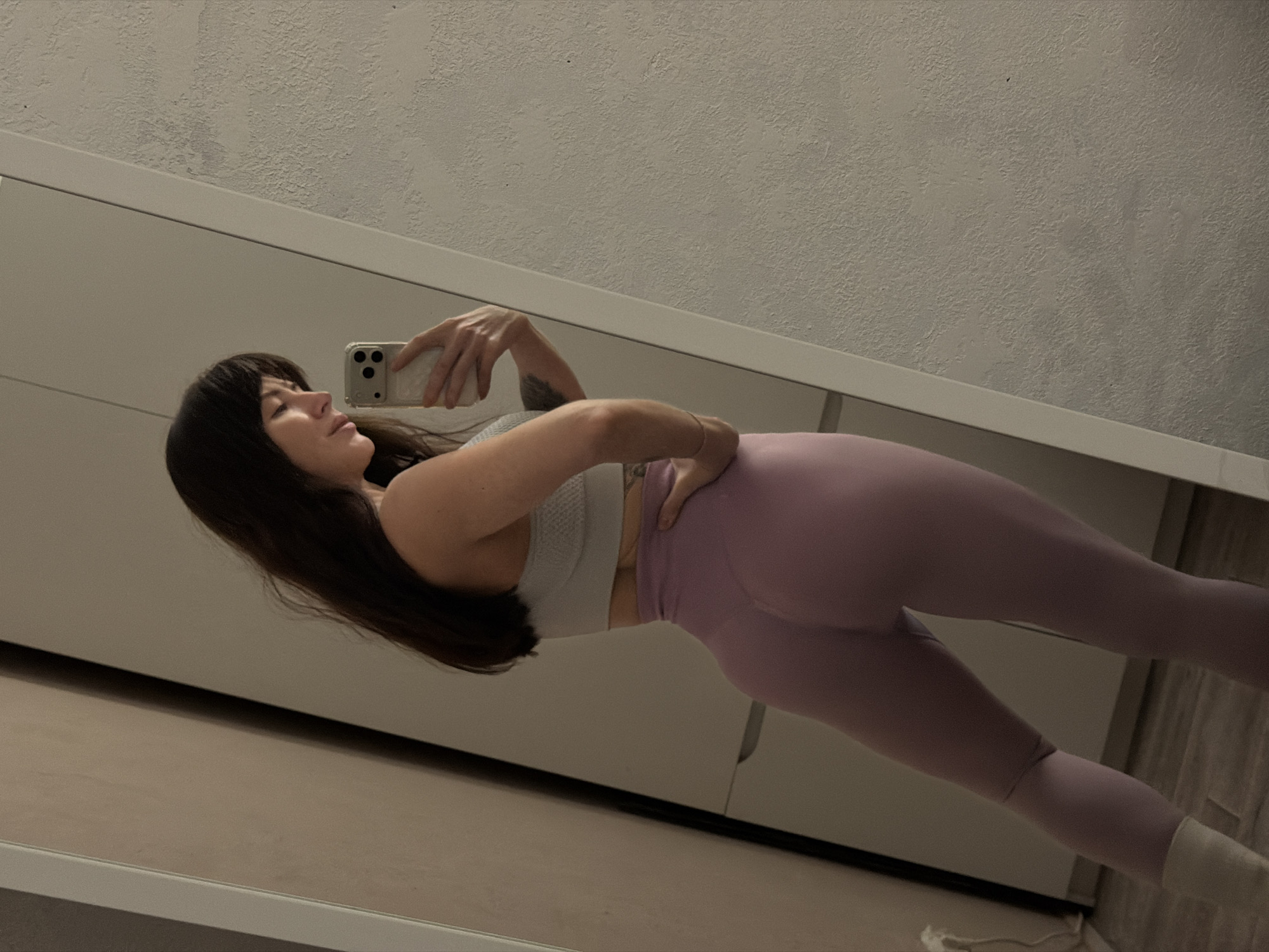 Woman takes mirror selfies in athletic wear in Perm