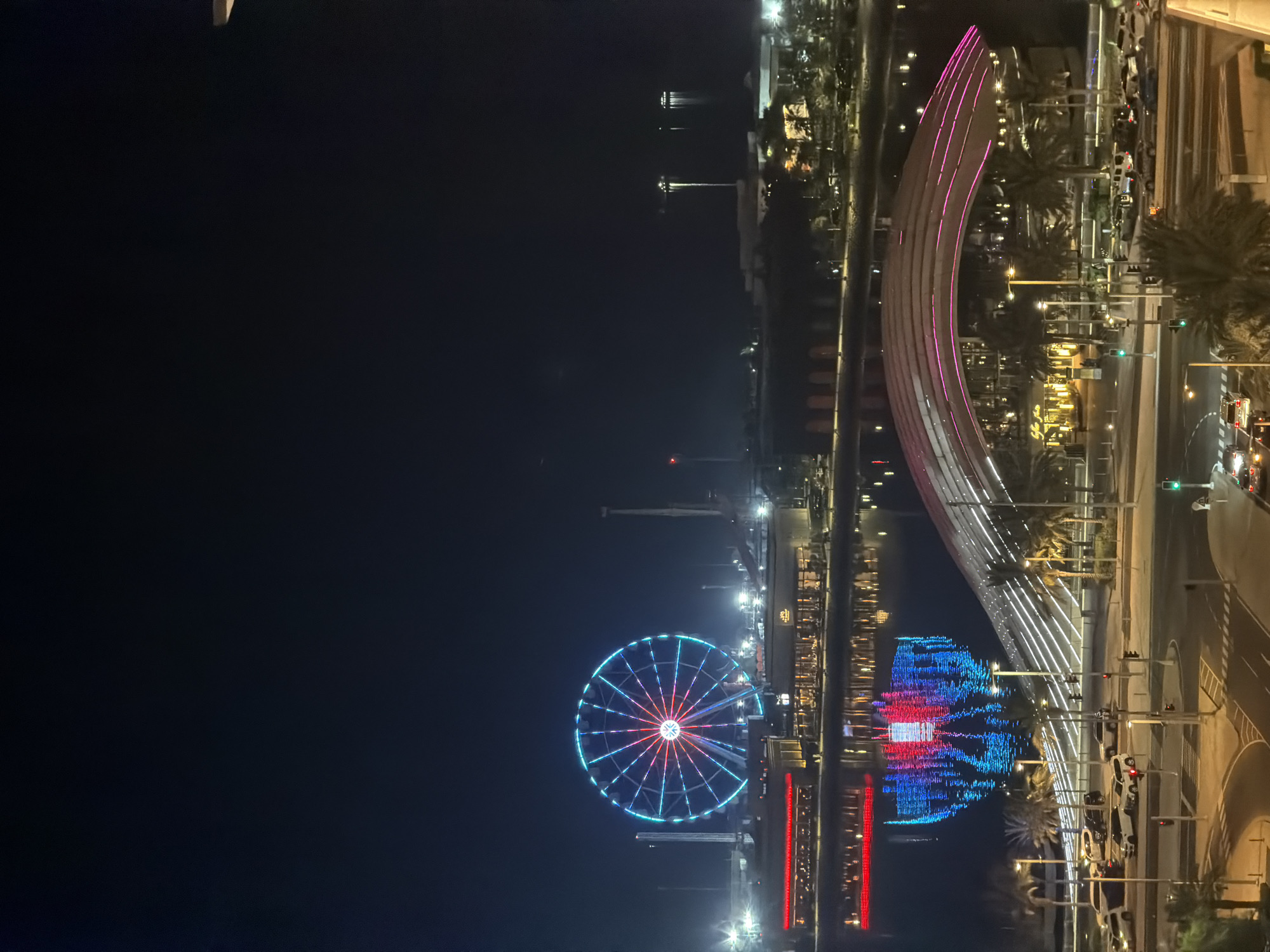Lusail waterfront Ferris wheel and bridge lit up at night