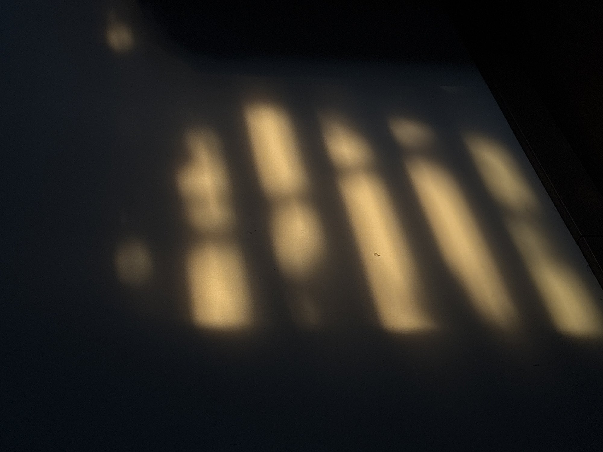 Golden sunlight creates striped shadows in Mexican home
