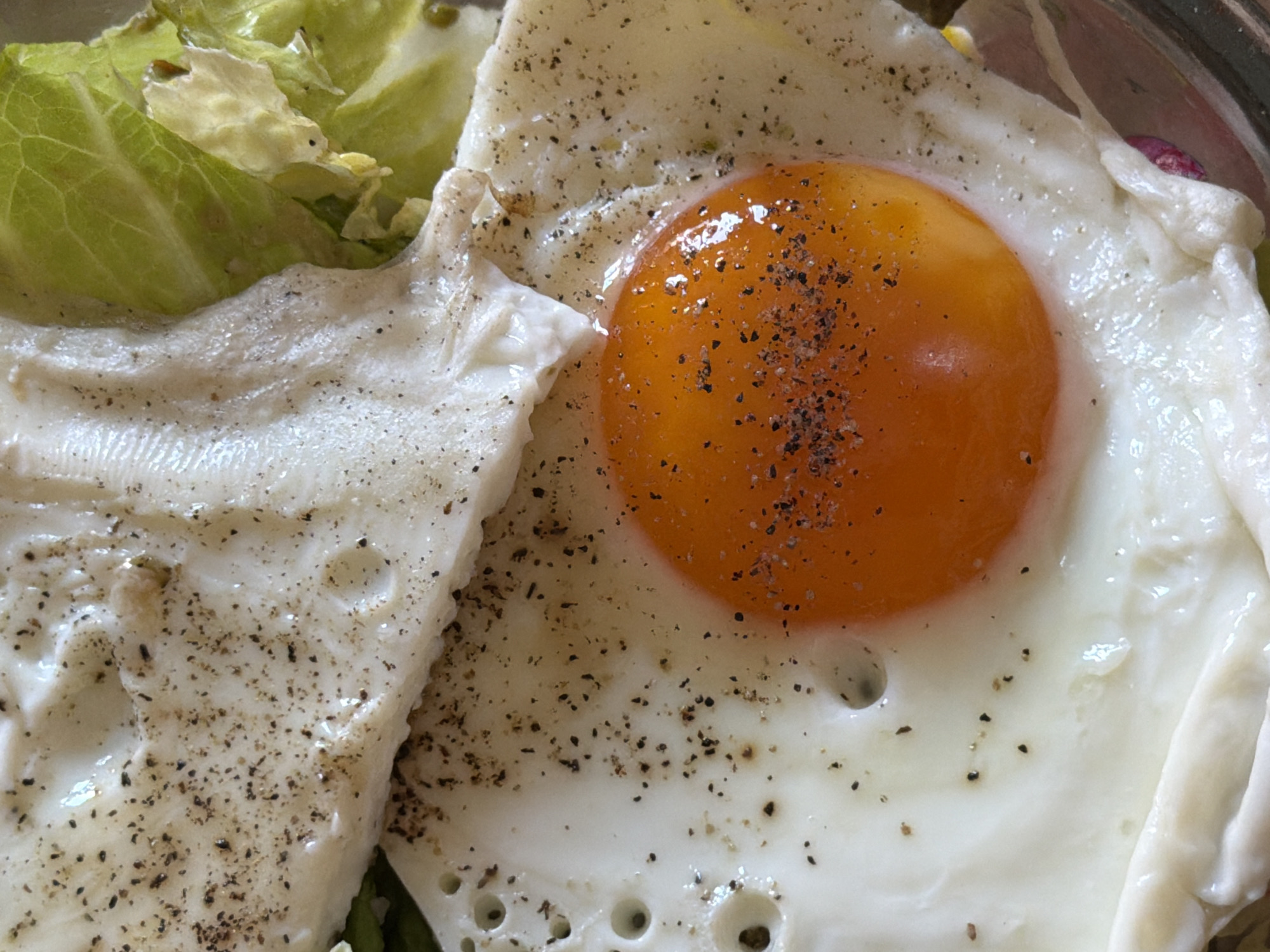 Fresh salad with fried eggs photographed in Catania