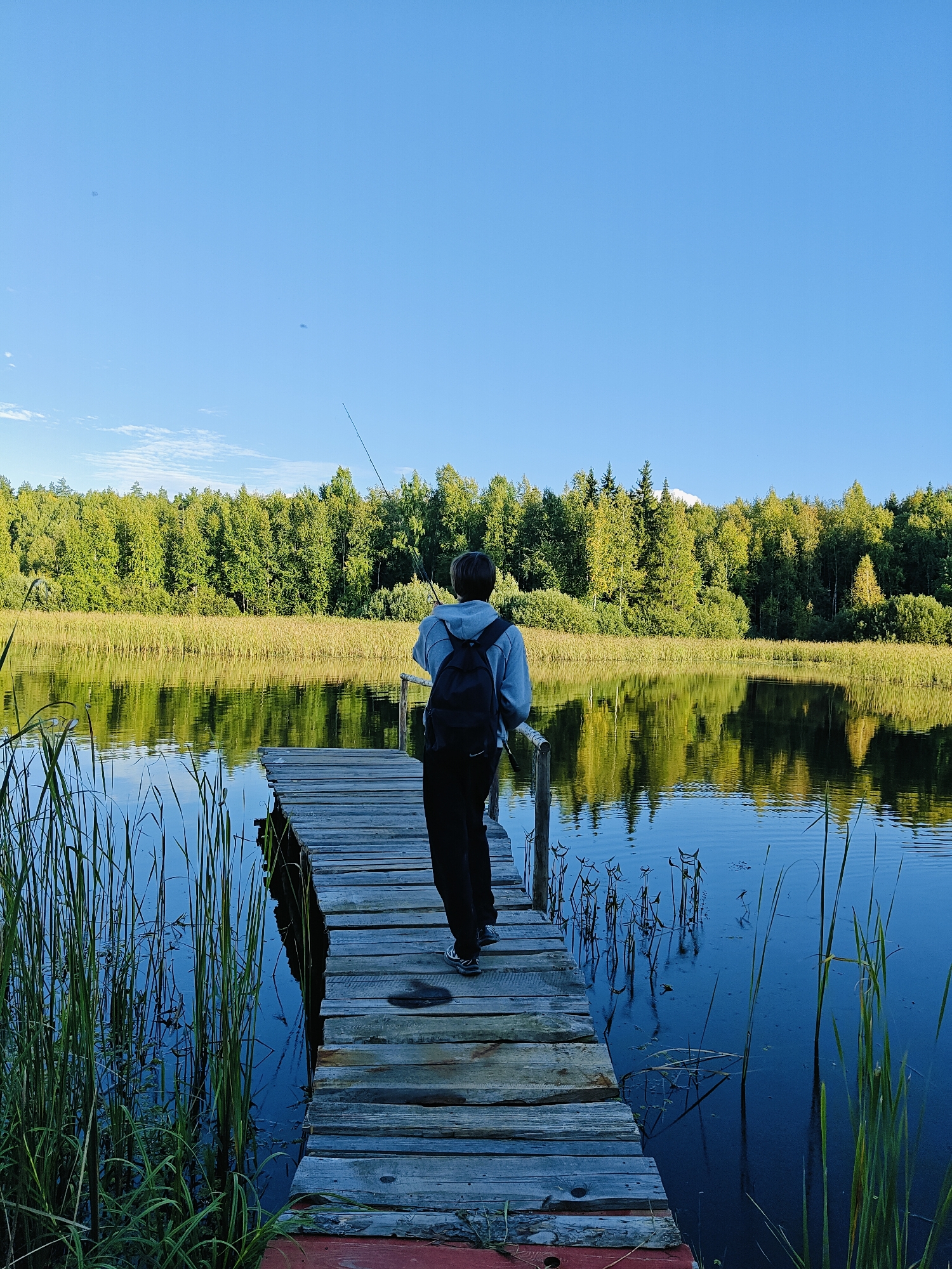 Fishing on a quiet lake pier in Chaikovsky, Russia