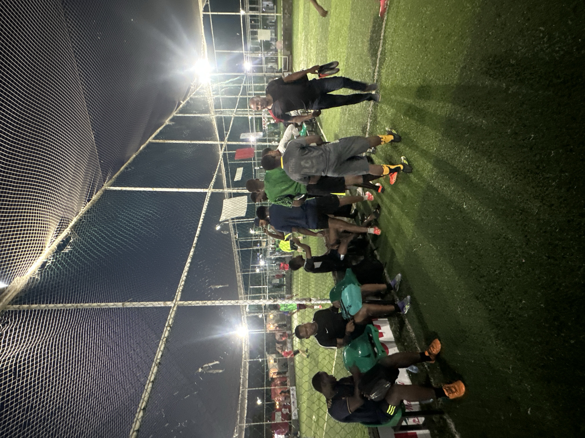 Evening football session on a floodlit turf pitch in Abuja