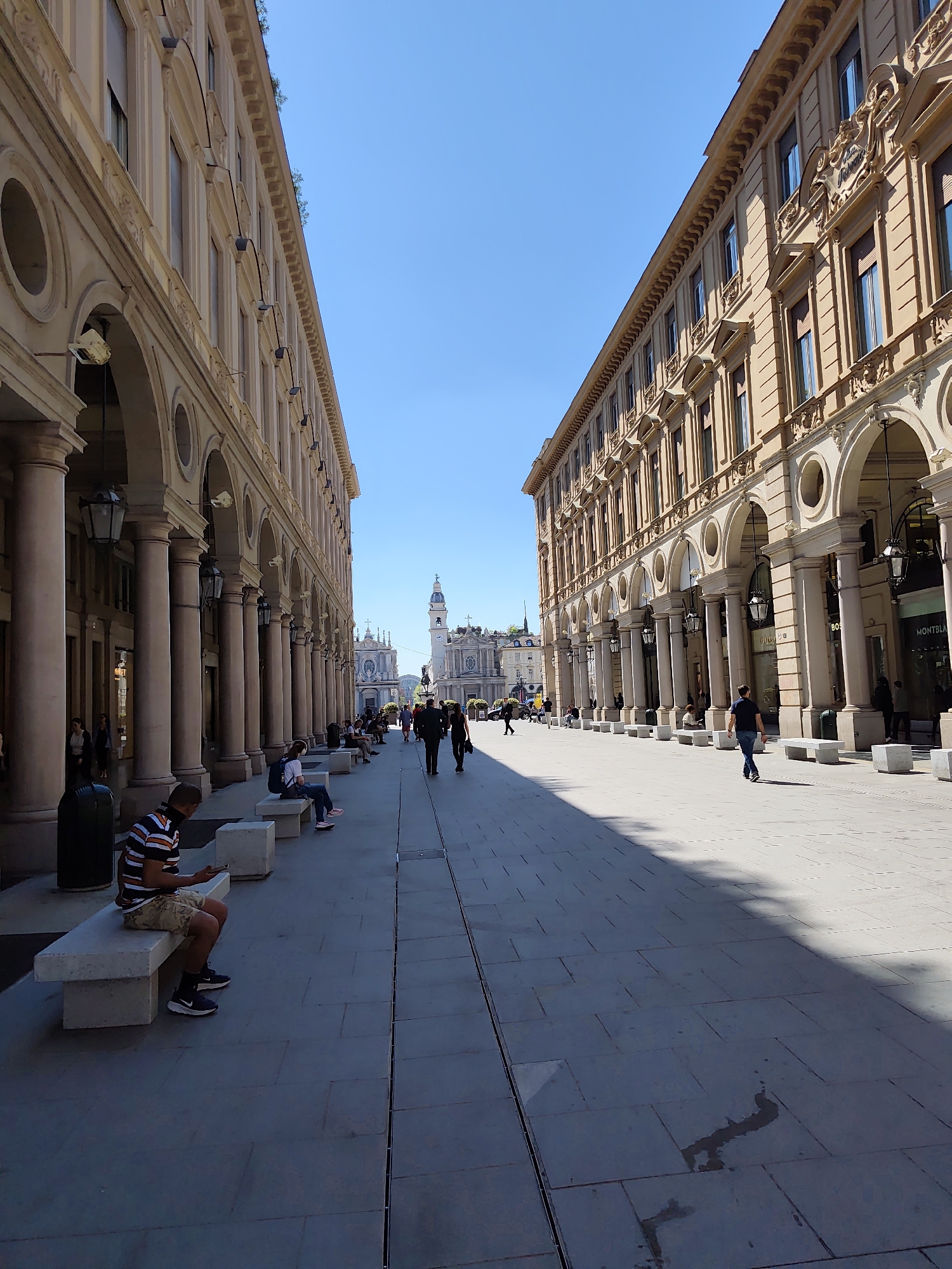 Turin shoppers encounter overturned head sculpture near Prada store