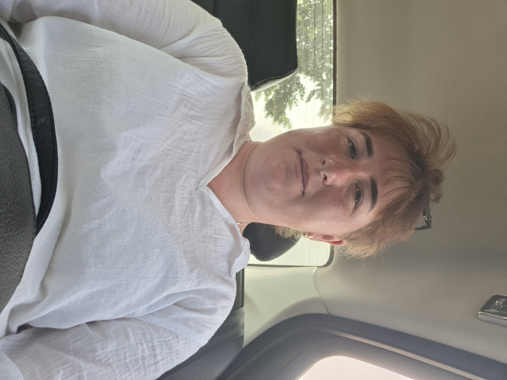 Back-seat selfie series, white shirt, reddish-brown hair
