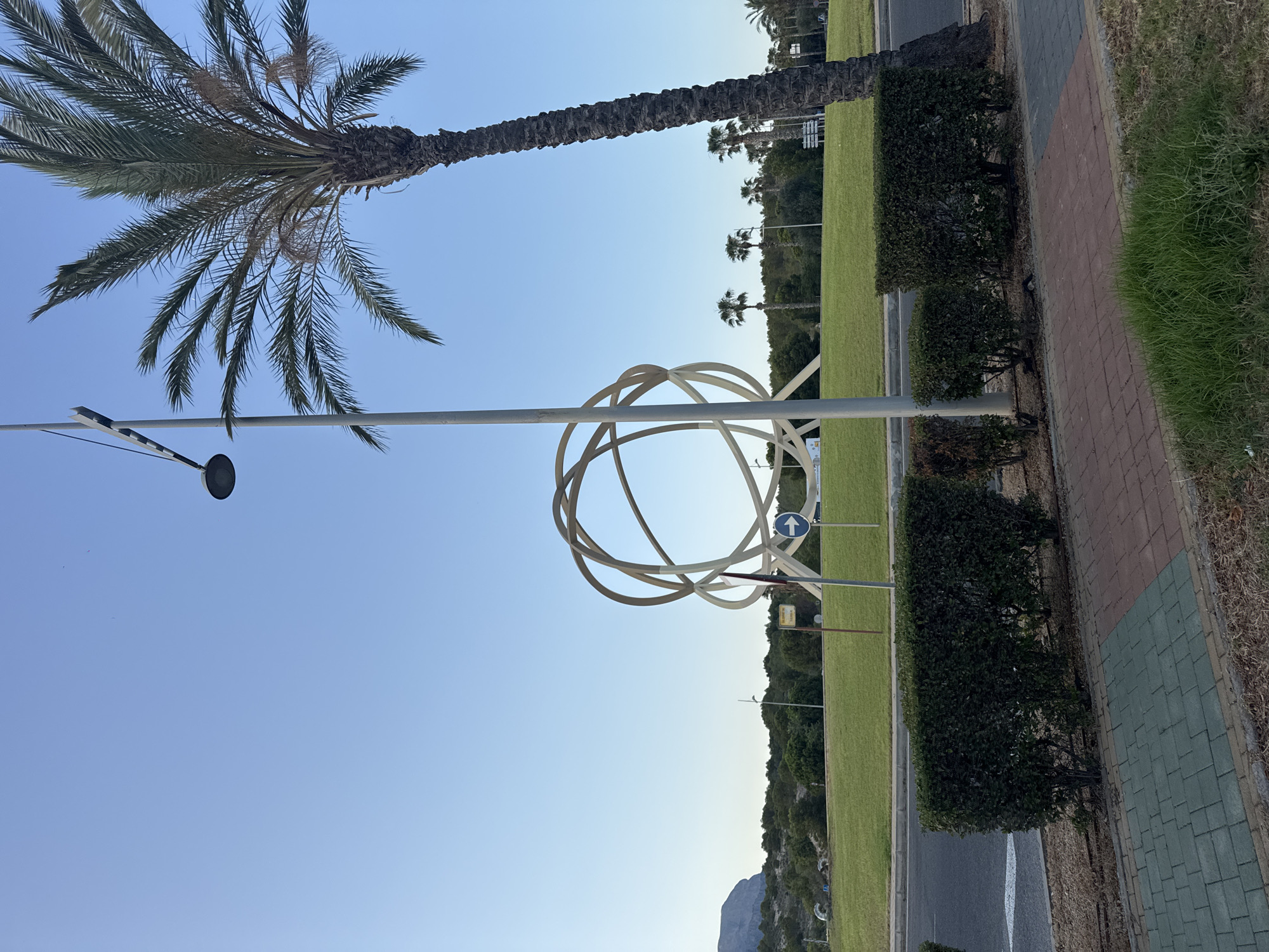 Benidorm roundabout sculpture and city skyline, June evening