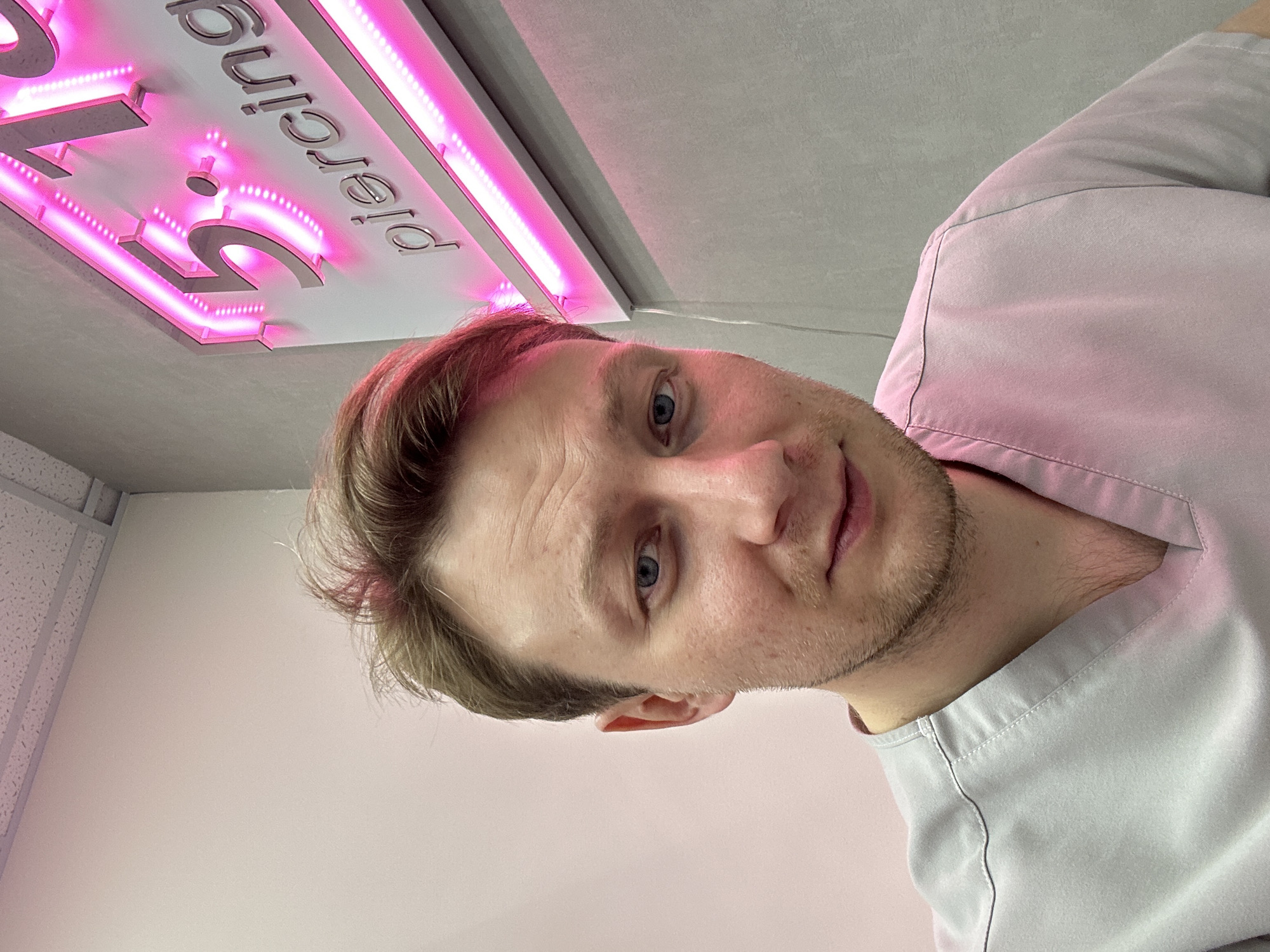 Medical worker takes selfie outside piercing shop in Sochi