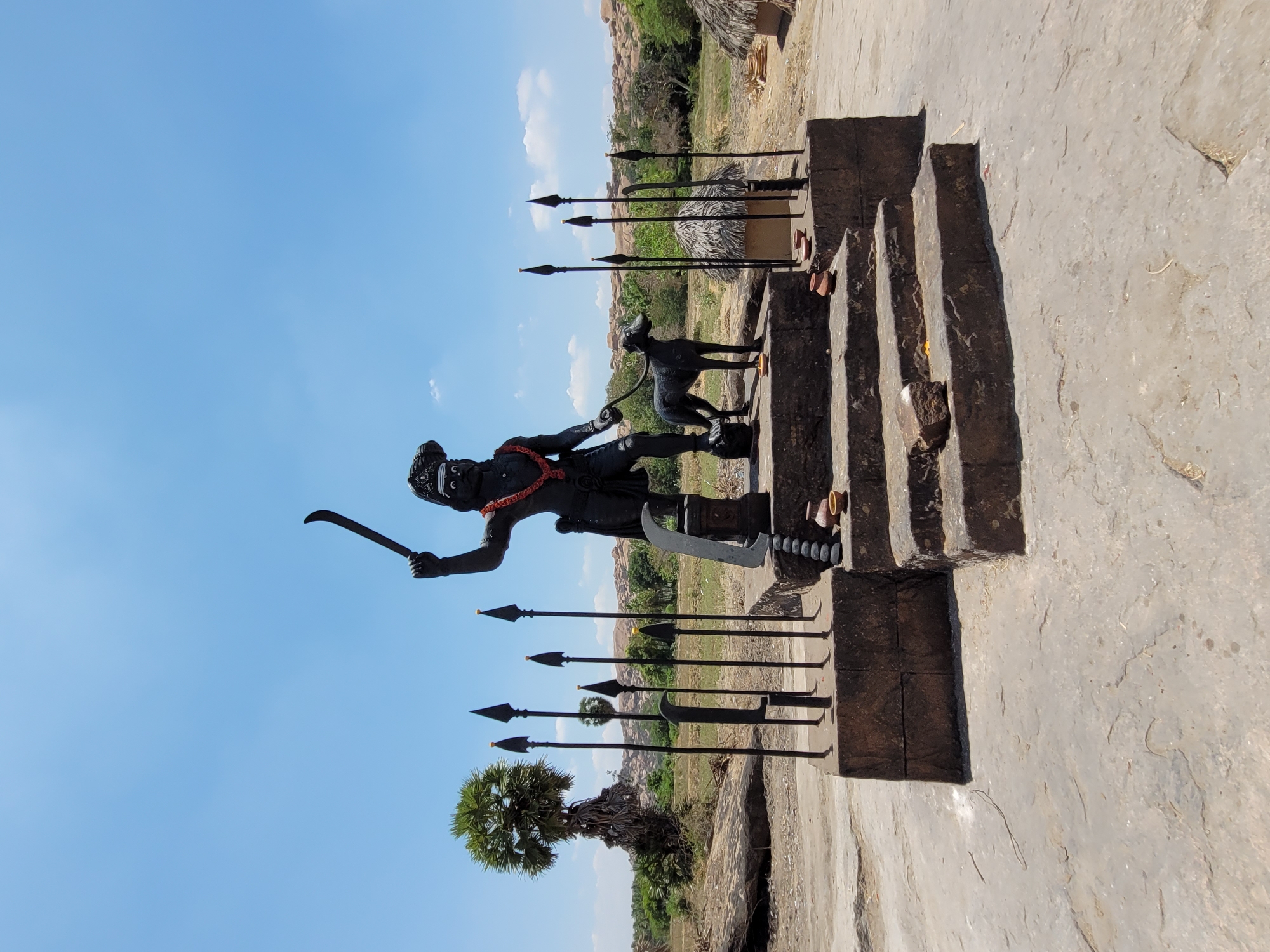 Historical settlement with dark statues photographed under blue skies