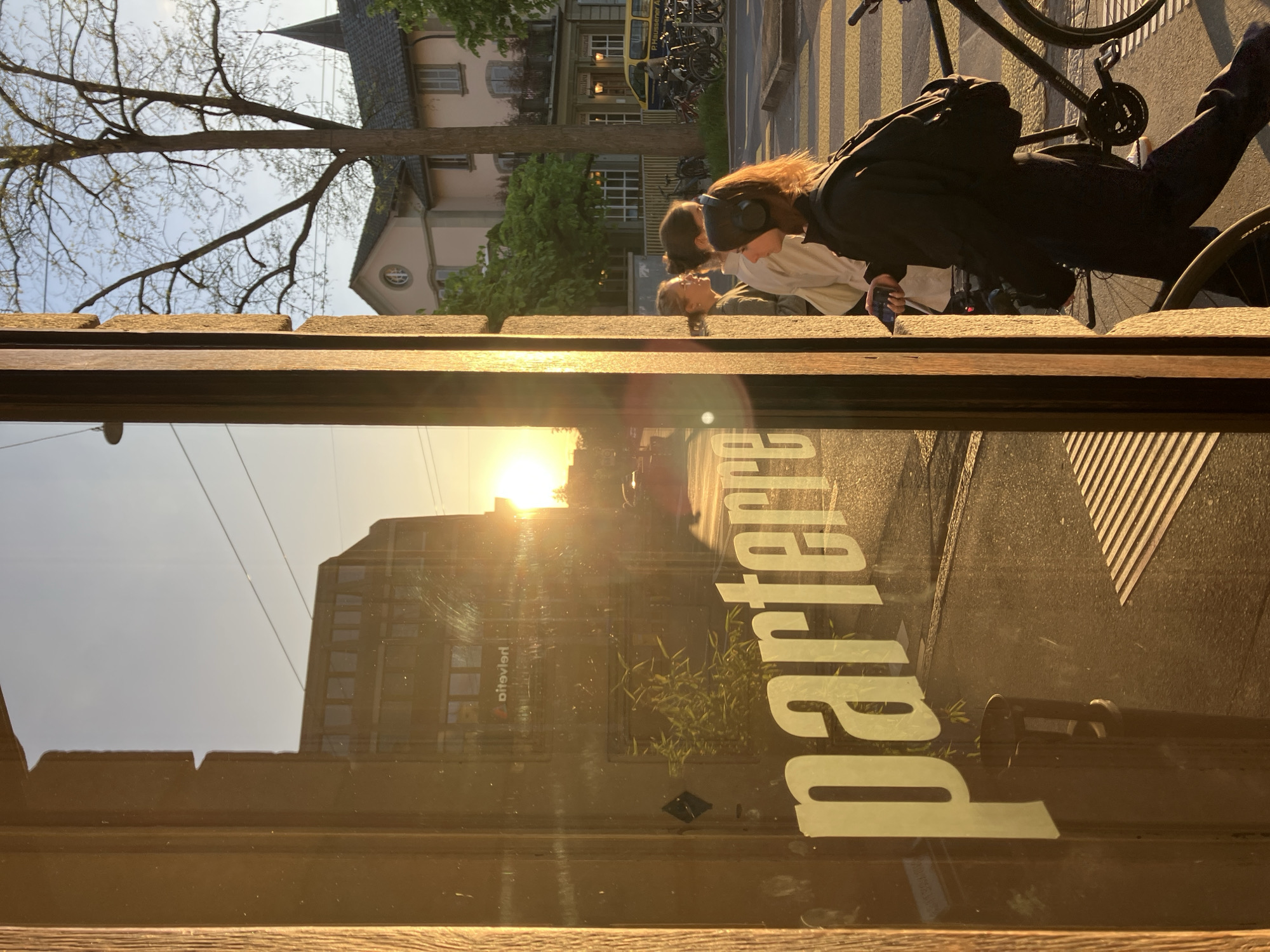 Street scene photographed through window in golden sunlight