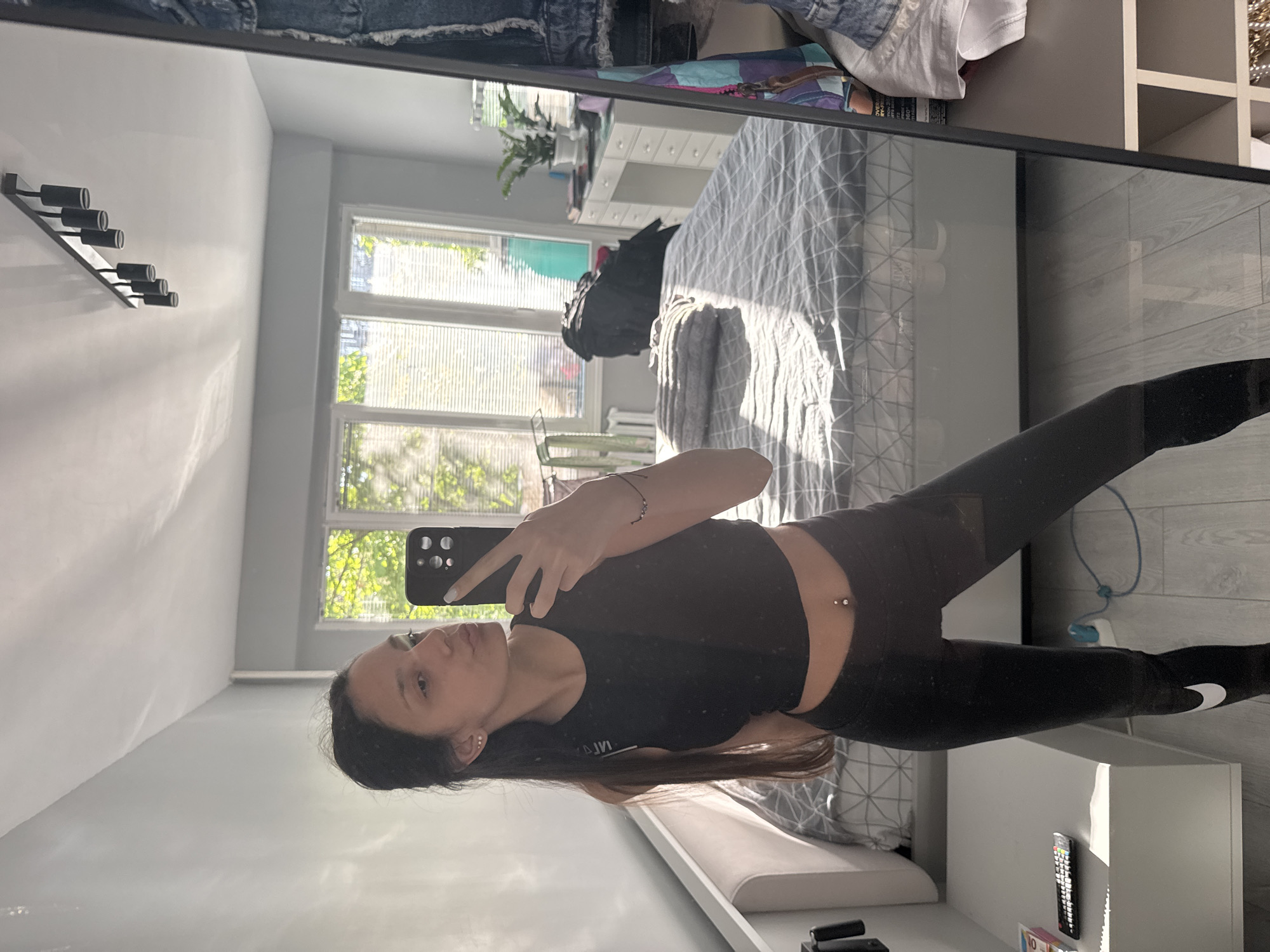 Woman takes early morning selfie in Sofia bedroom