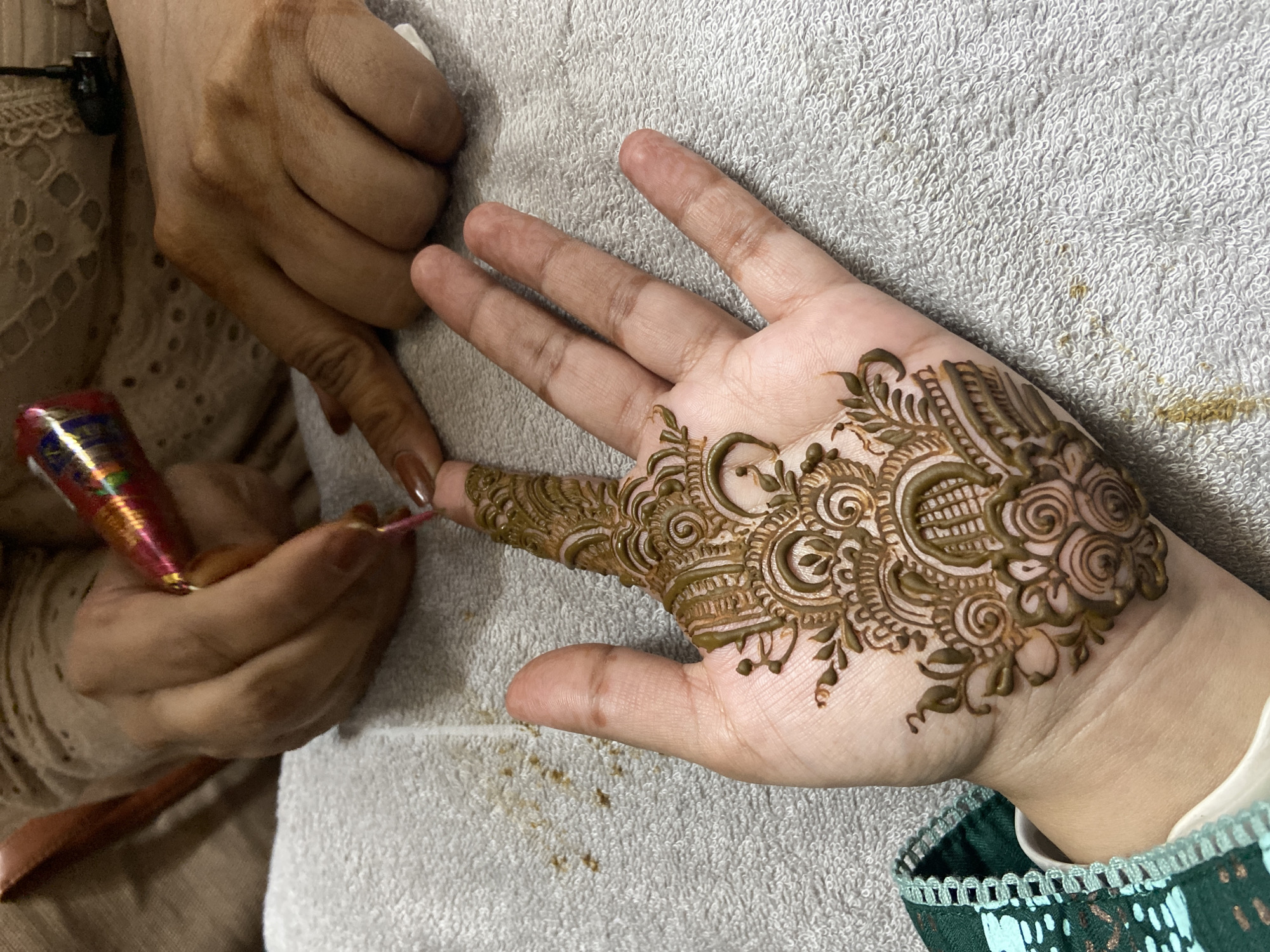 Elaborate henna designs applied to hand in Dhaka