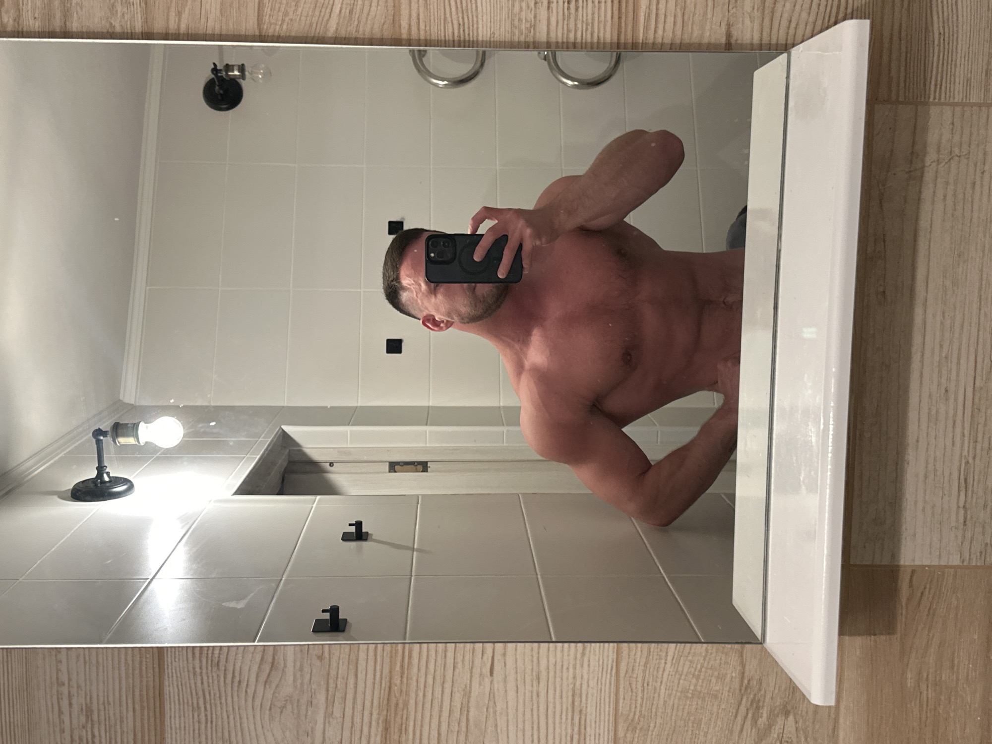 Person takes bathroom mirror selfie in Perm, Russia