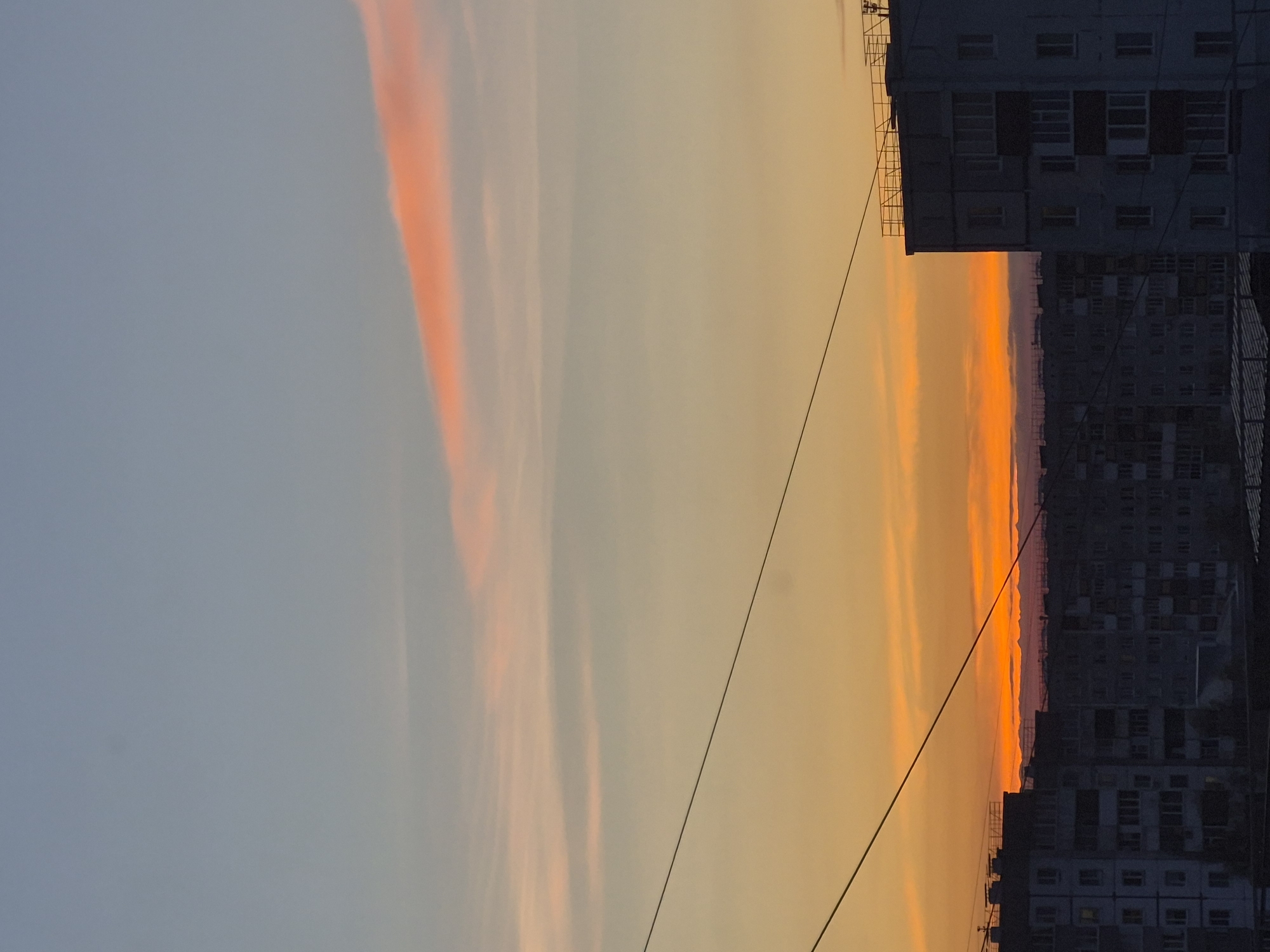 Child plays outdoors in Tobolsk during afternoon sunset