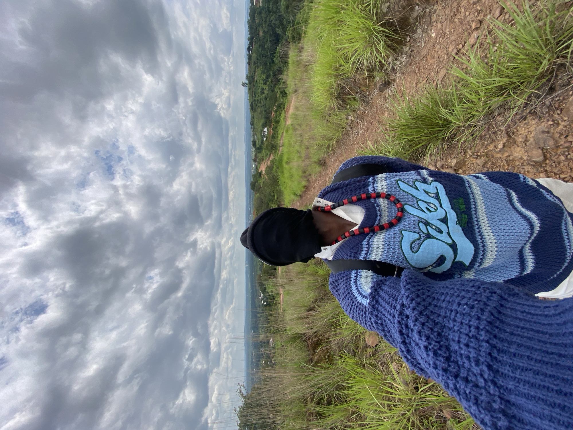 Pausing on a dirt path in Nigeria's hilly countryside