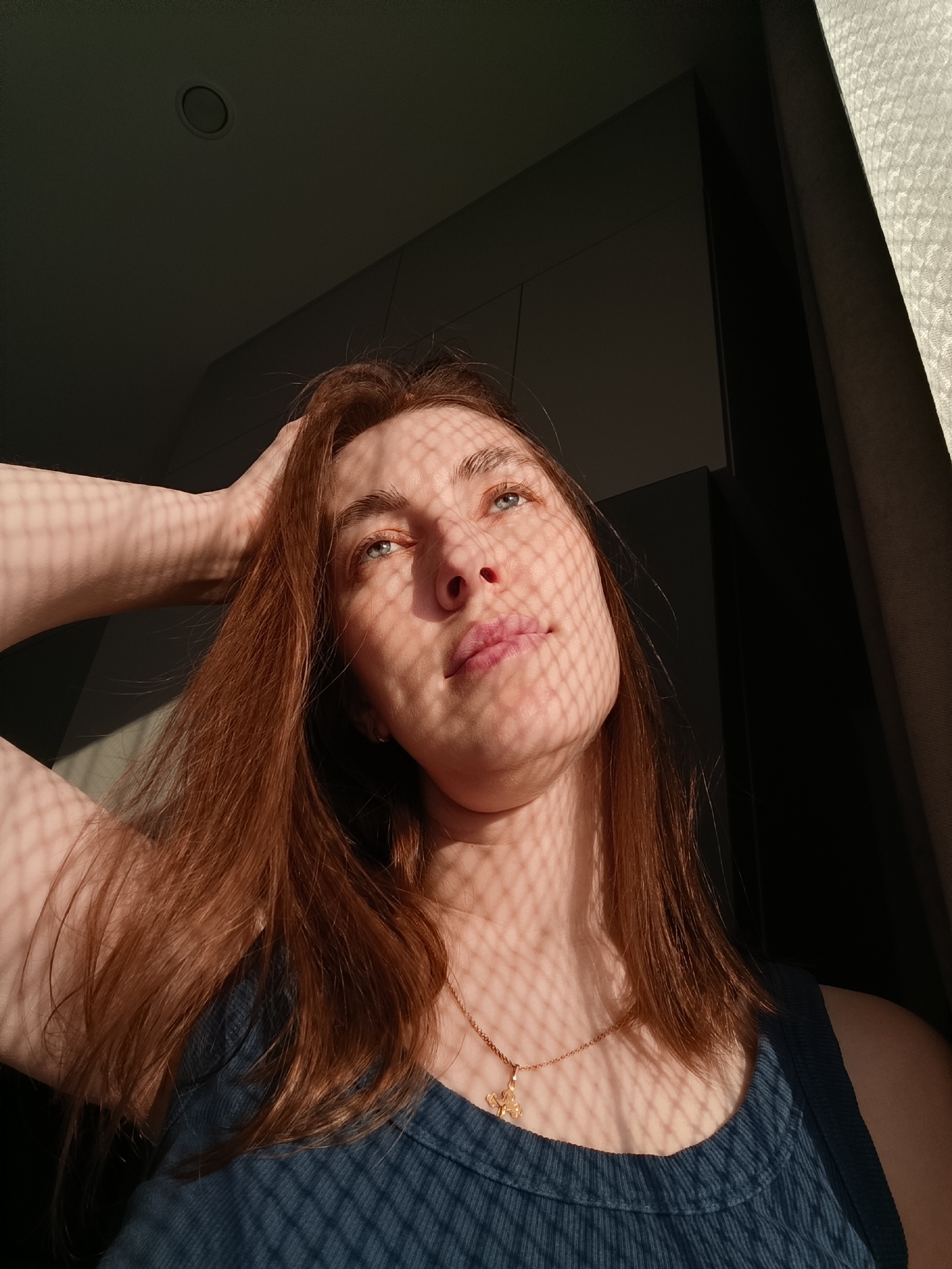 Woman documents afternoon at home with selfies in Chaikovsky
