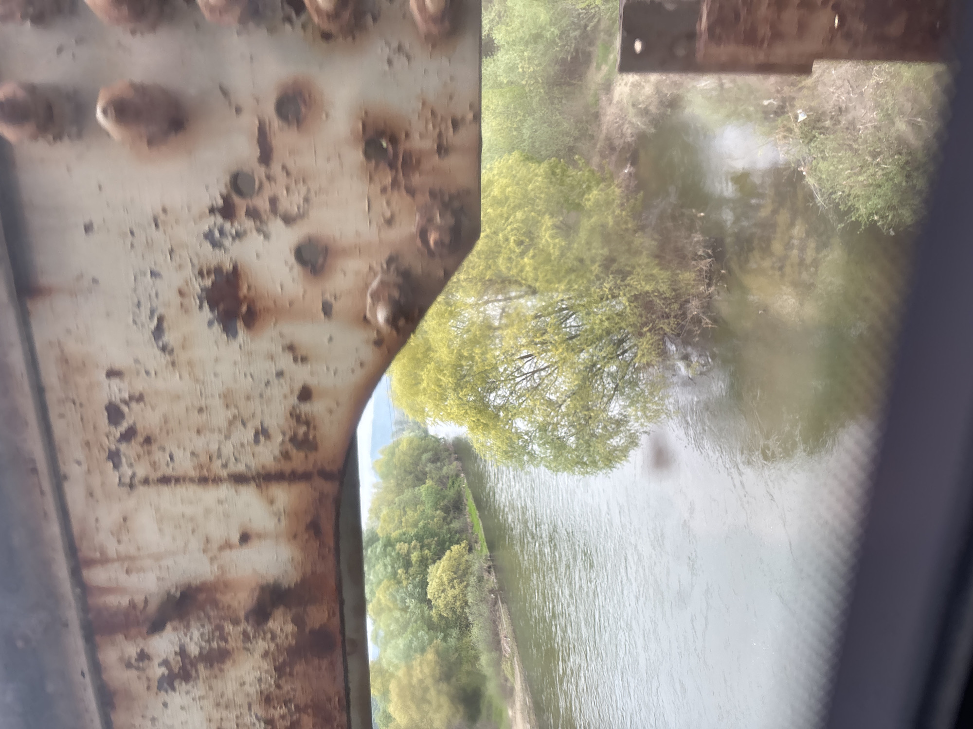Train journey documented through bridges, stations, and mountain scenery