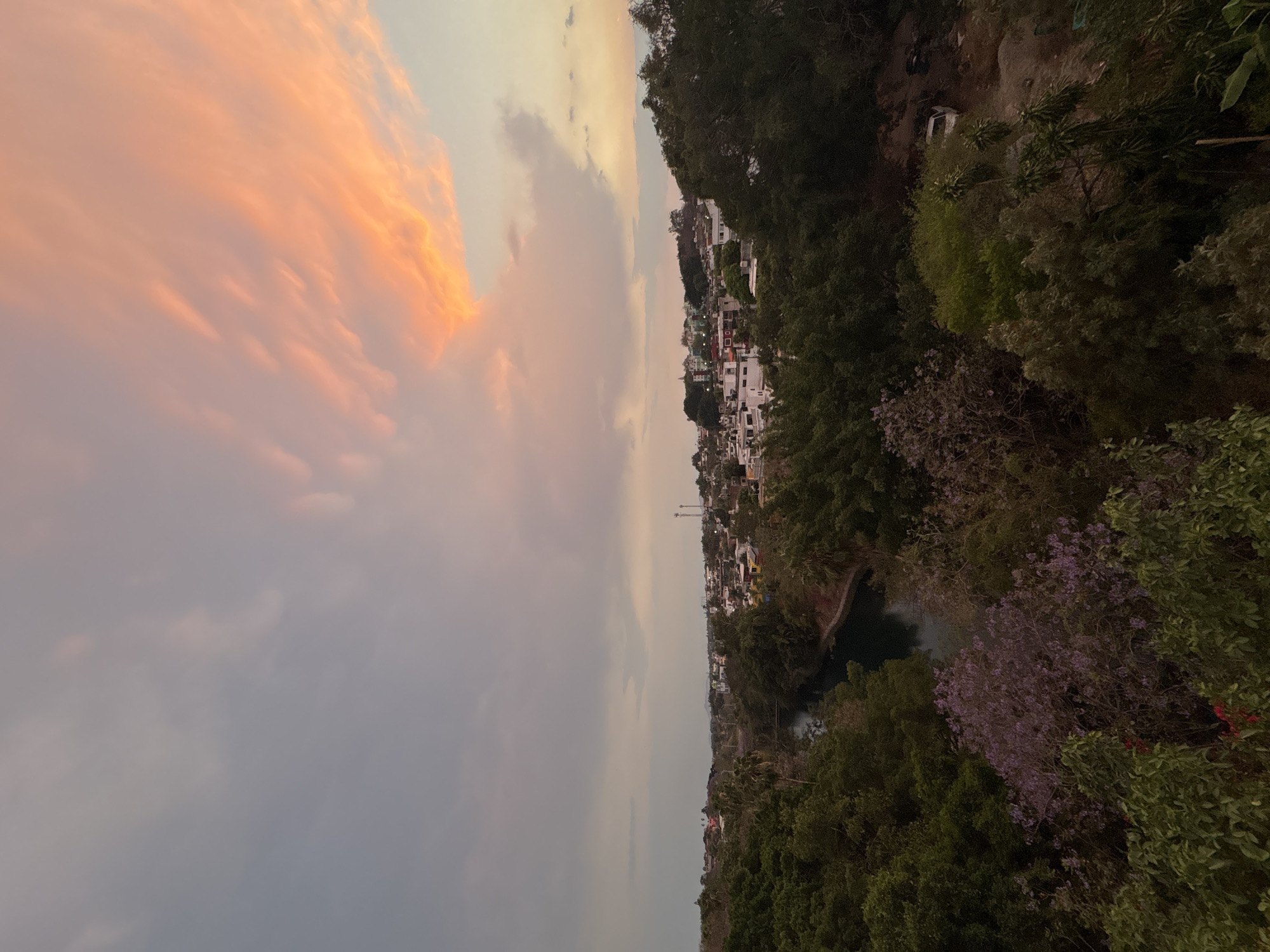 Dusk sky creates pink gradient over Cuernavaca cityscape
